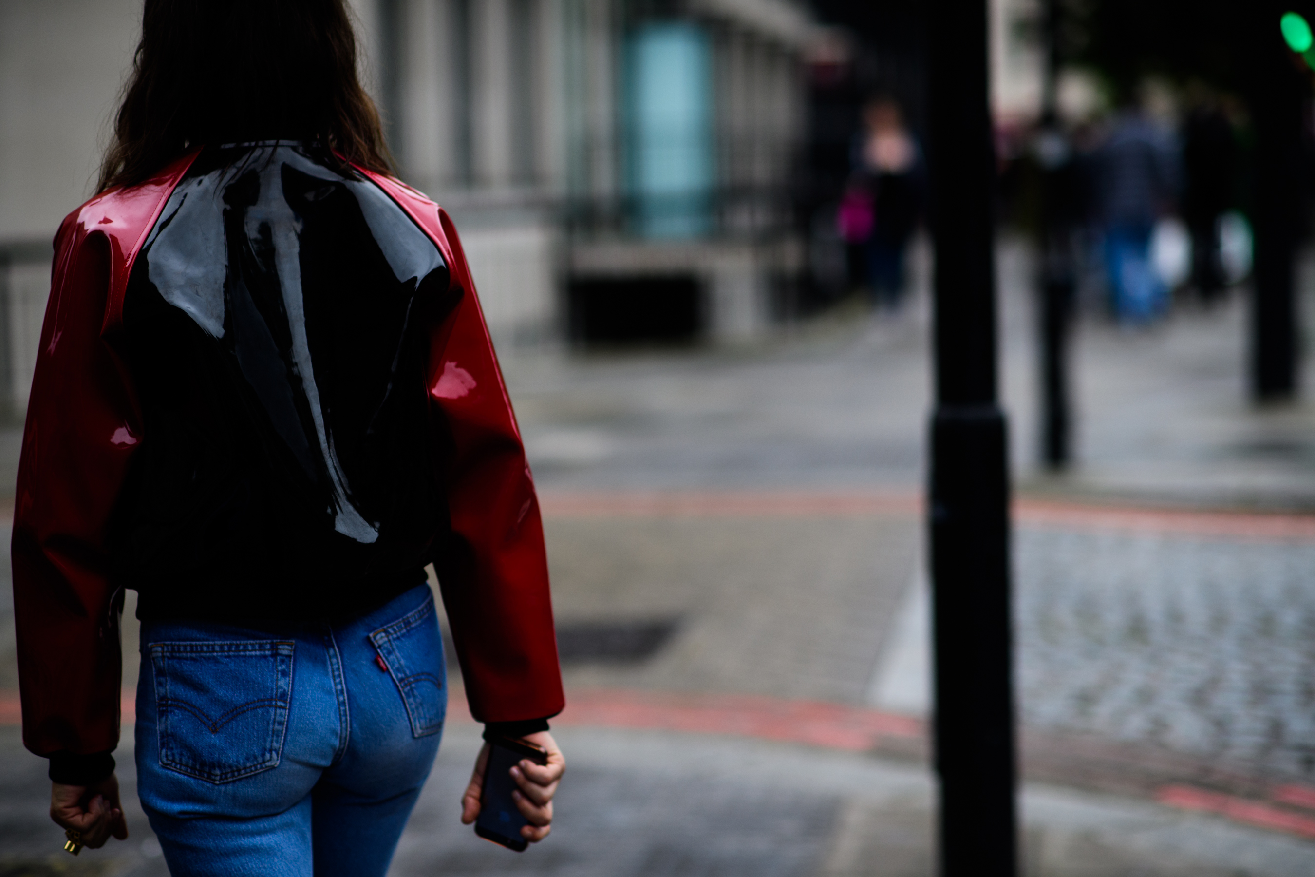 A woman in a black and red jacket