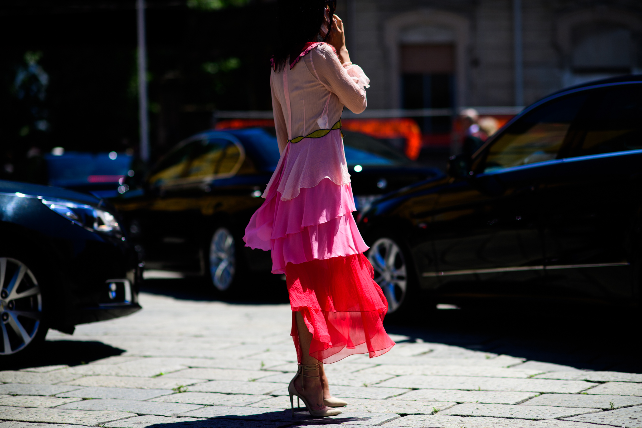 A woman in a pink an red skirt