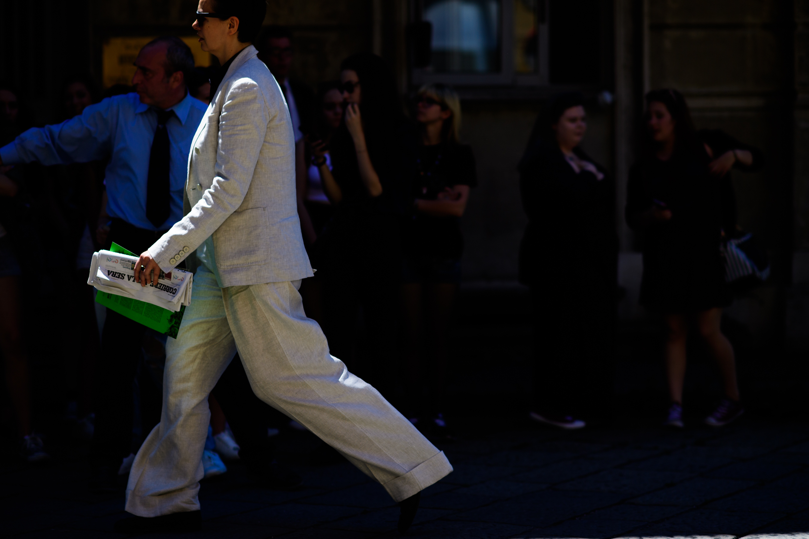A woman wearing a white suit