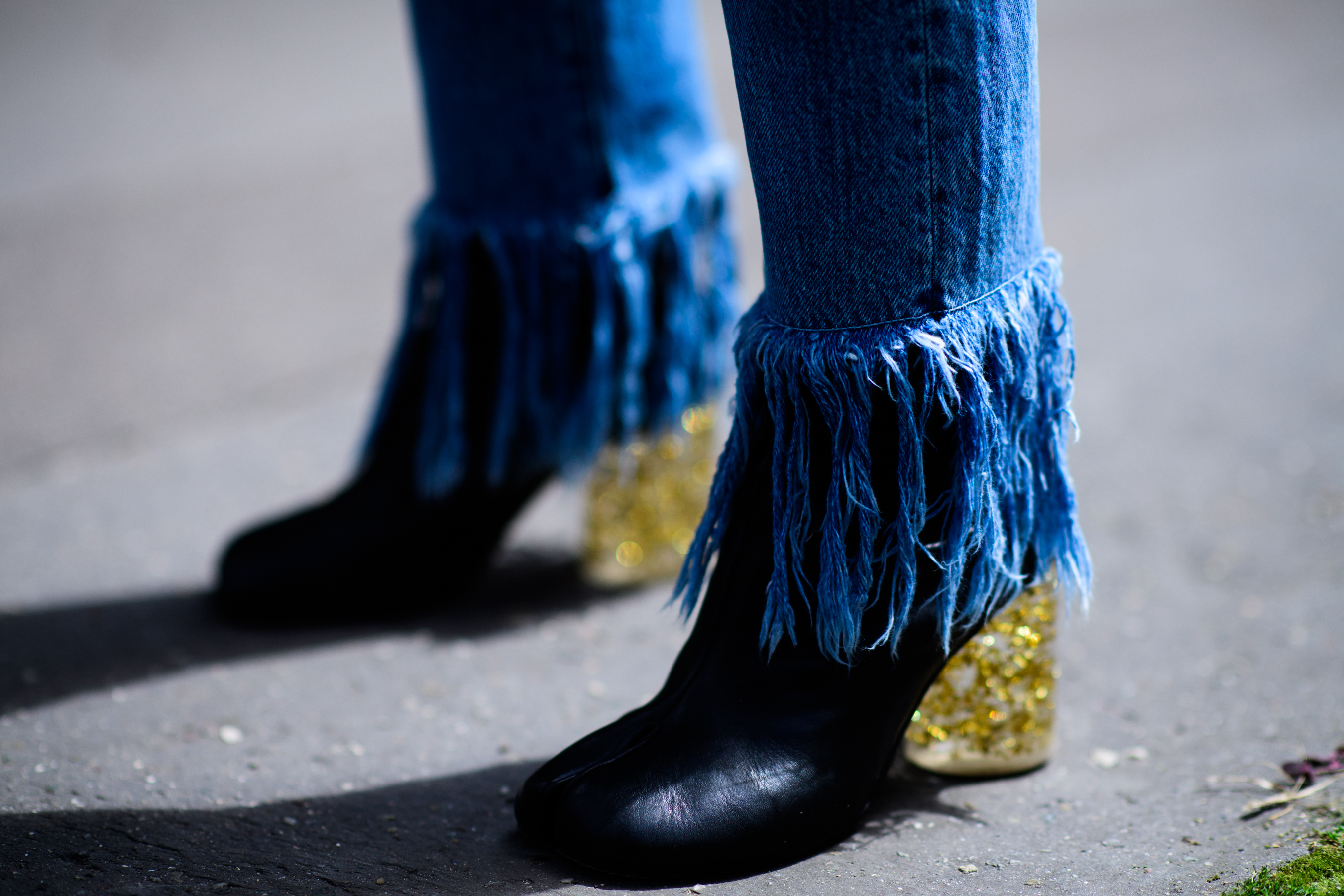 Blue trousers, black high-heeled shoes