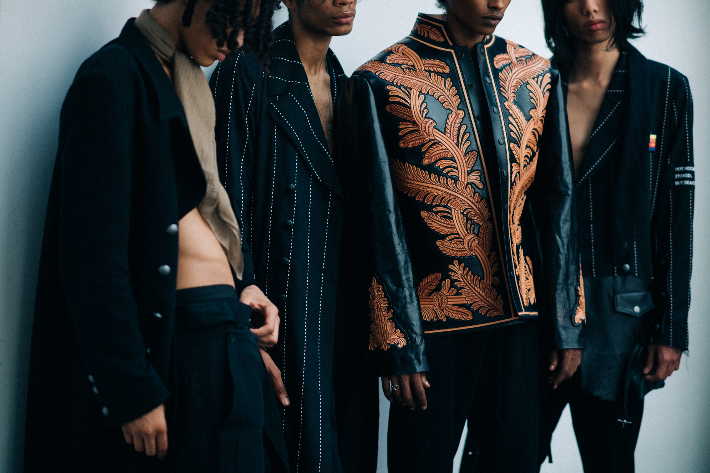 Four male models posing together