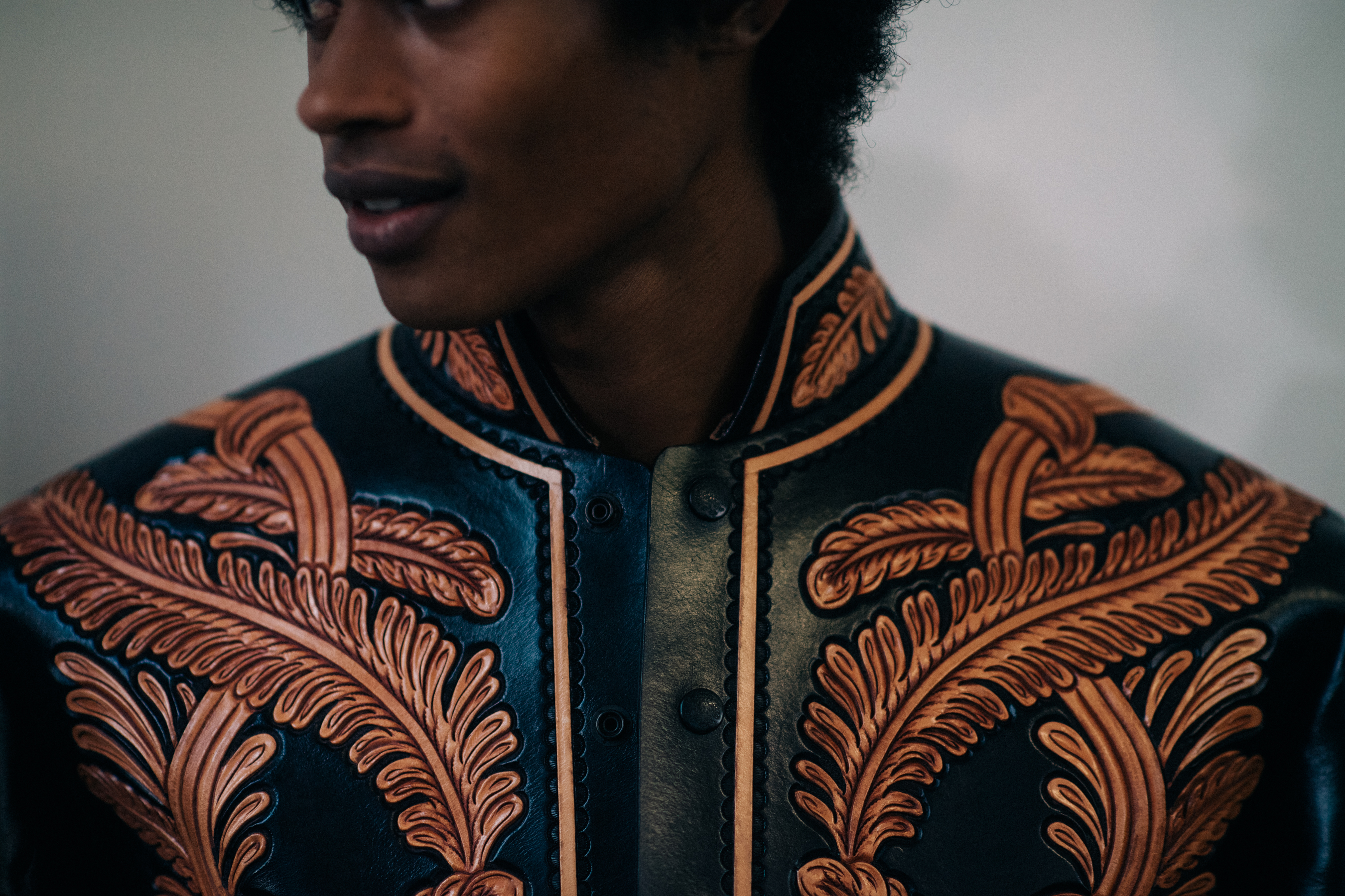 Male model wearing embroidered jacket