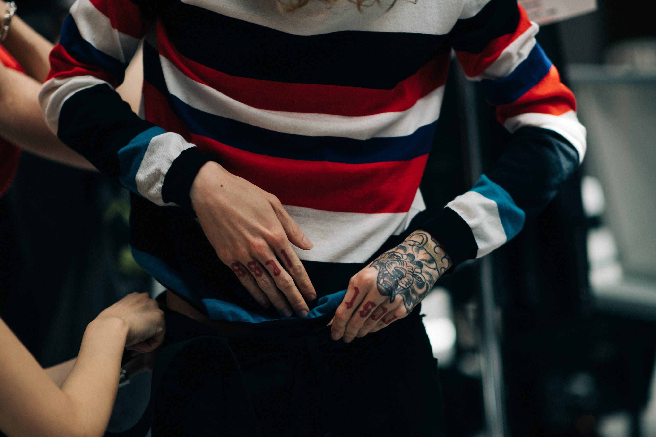 Male model wearing colourful sweater