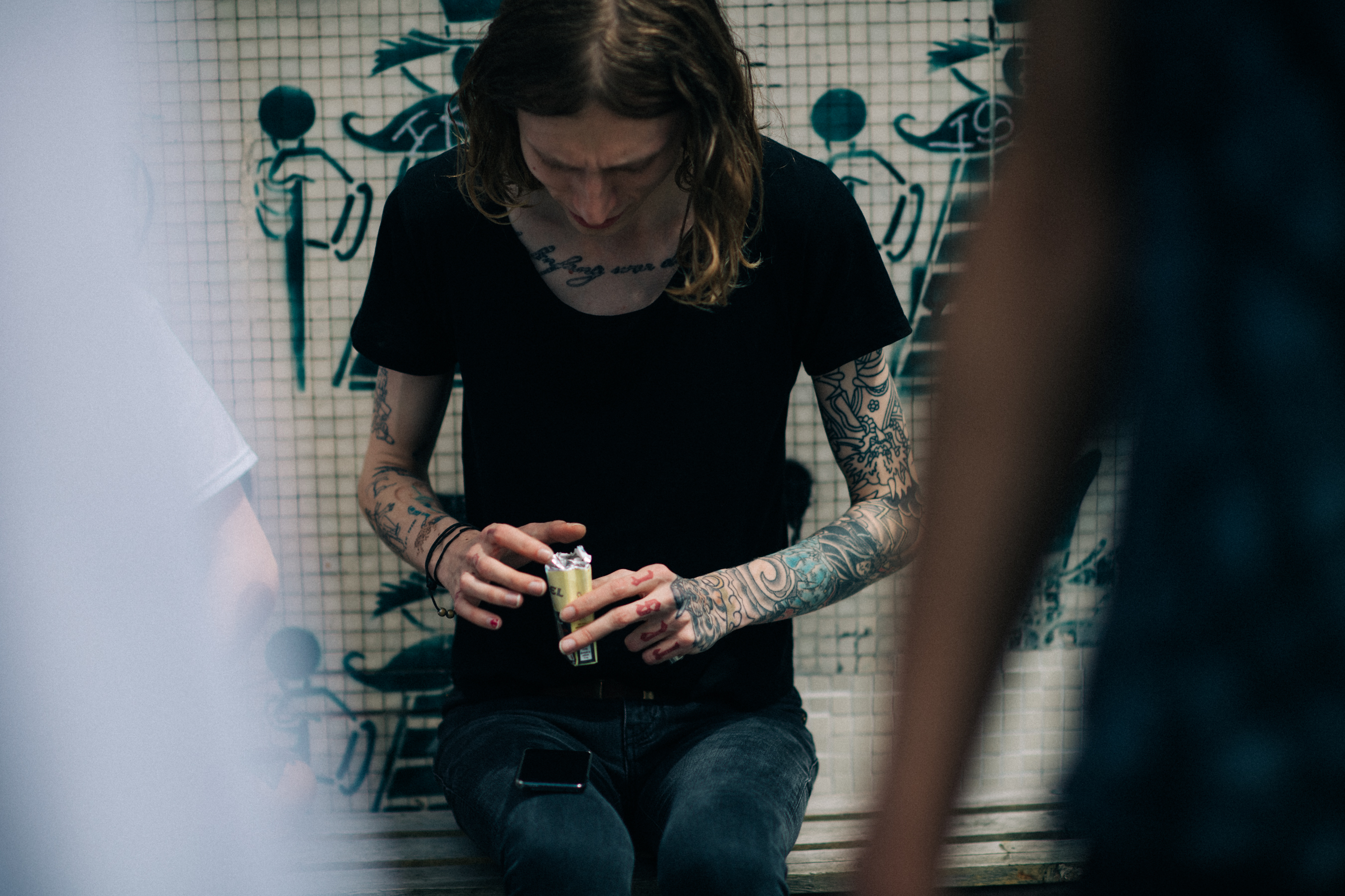 Tattooed model wearing black T-Shirt