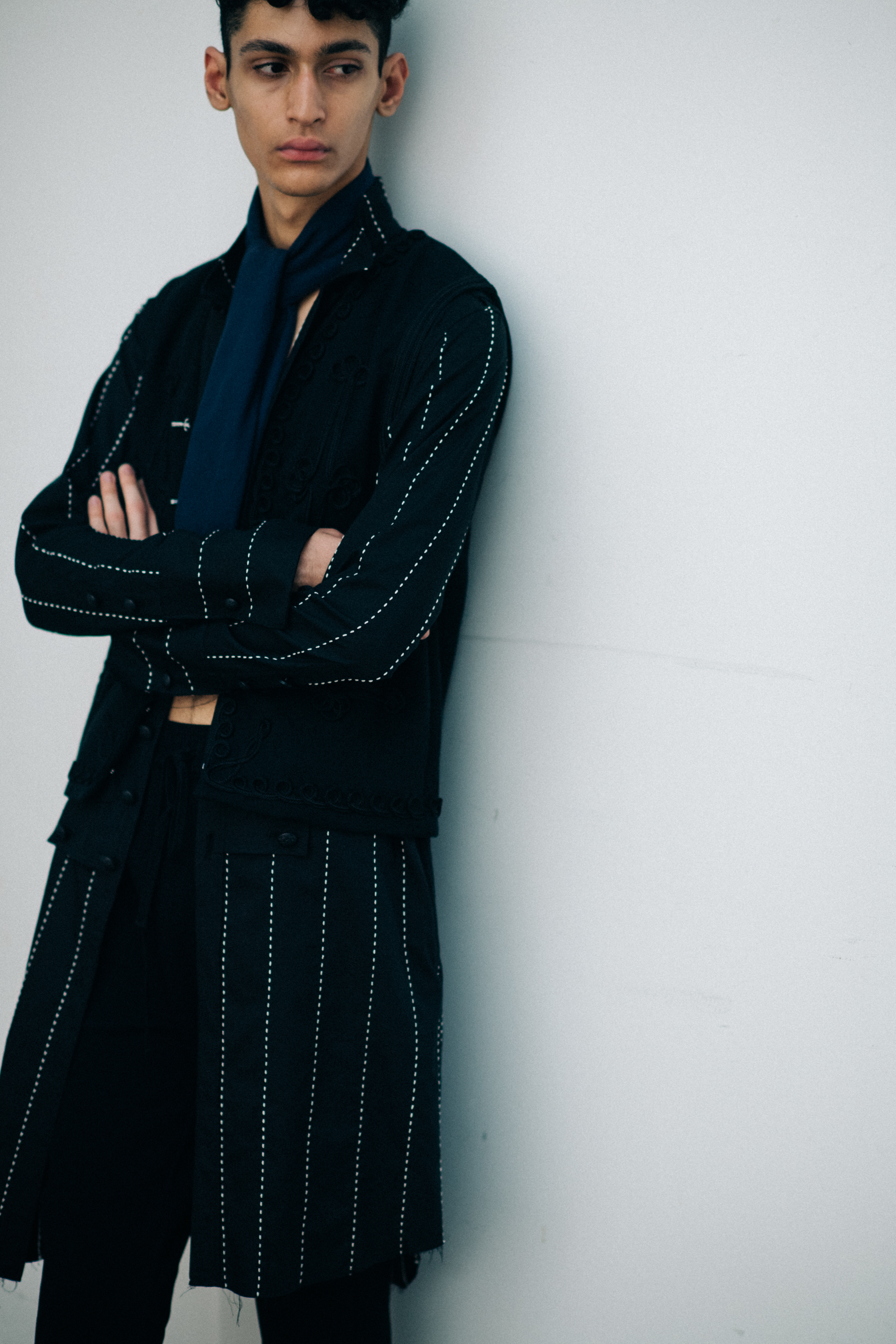 Model wearing black striped trousers