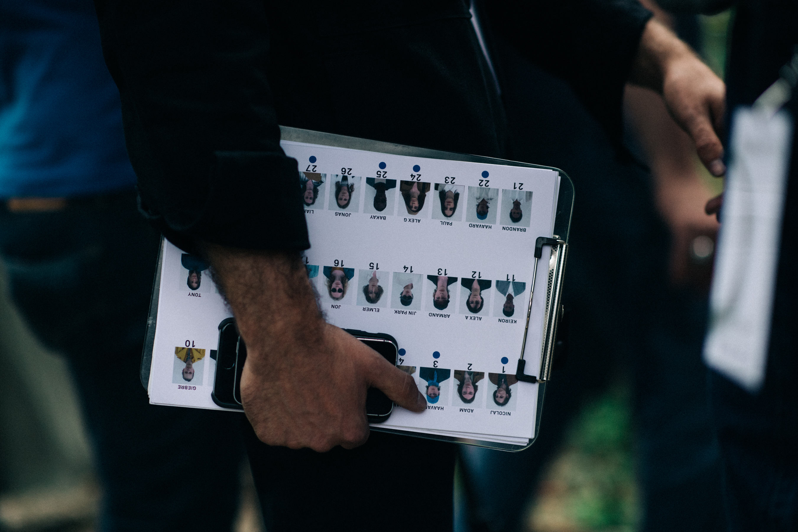 Man holding papers with photos