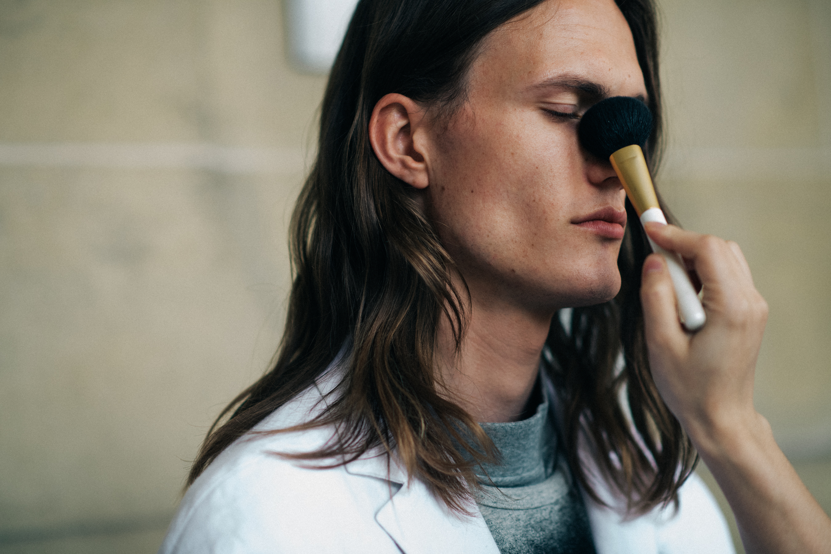 Male model getting make-up done
