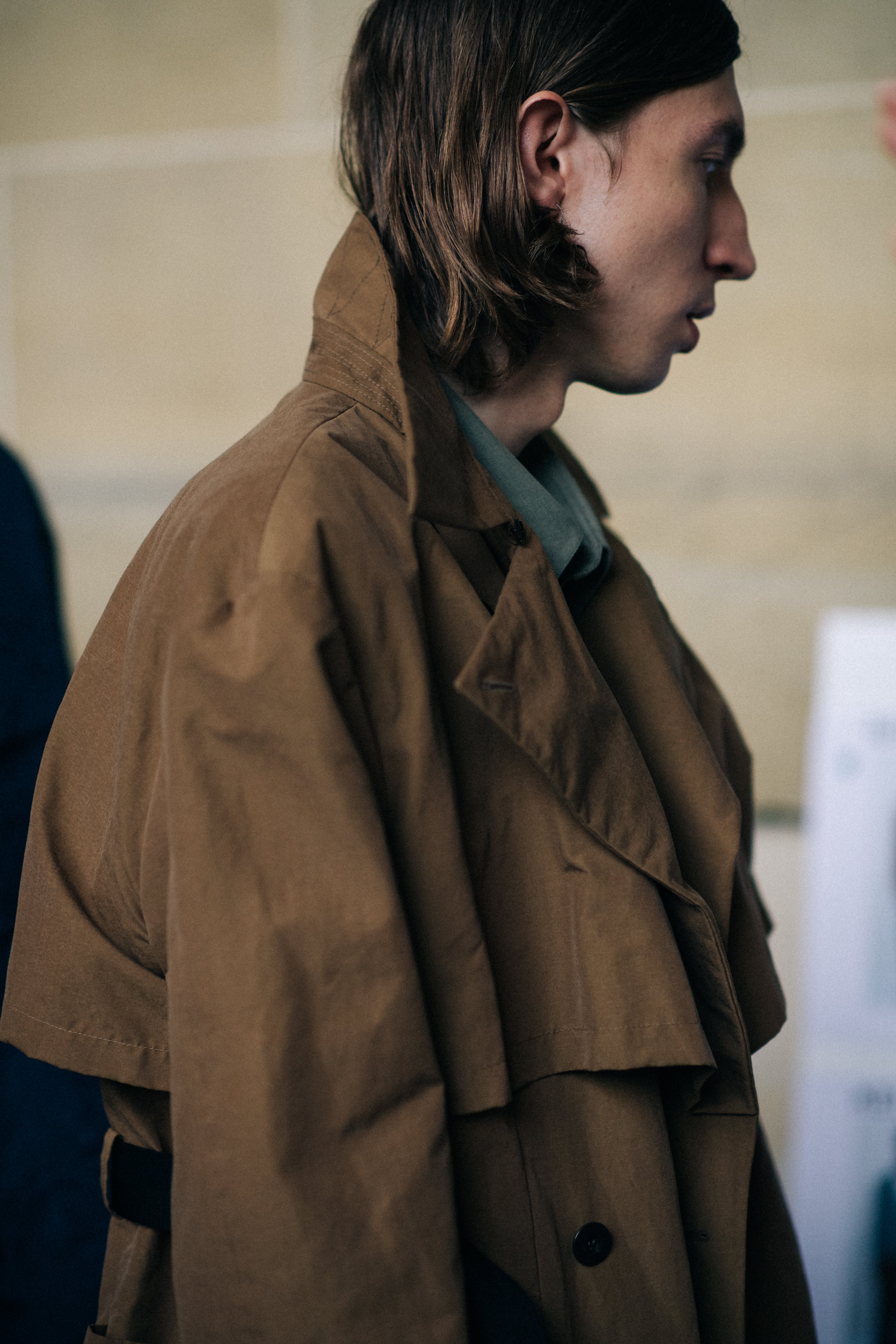 Male model wearing brown coat