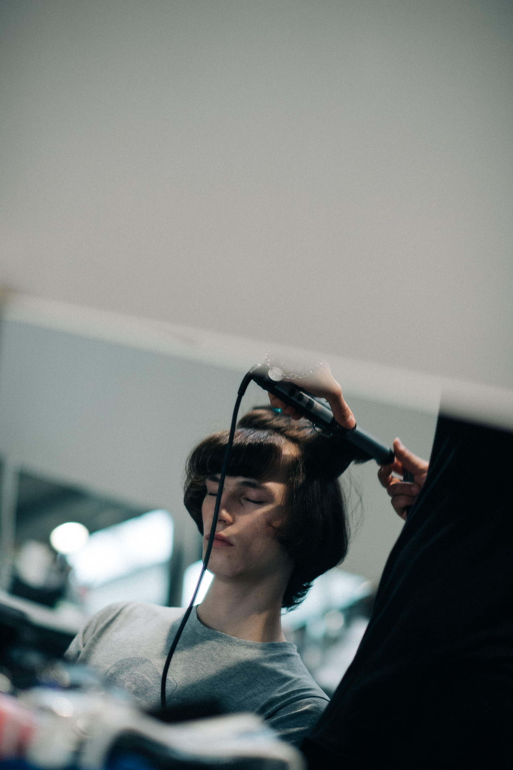 A male model getting his hair done