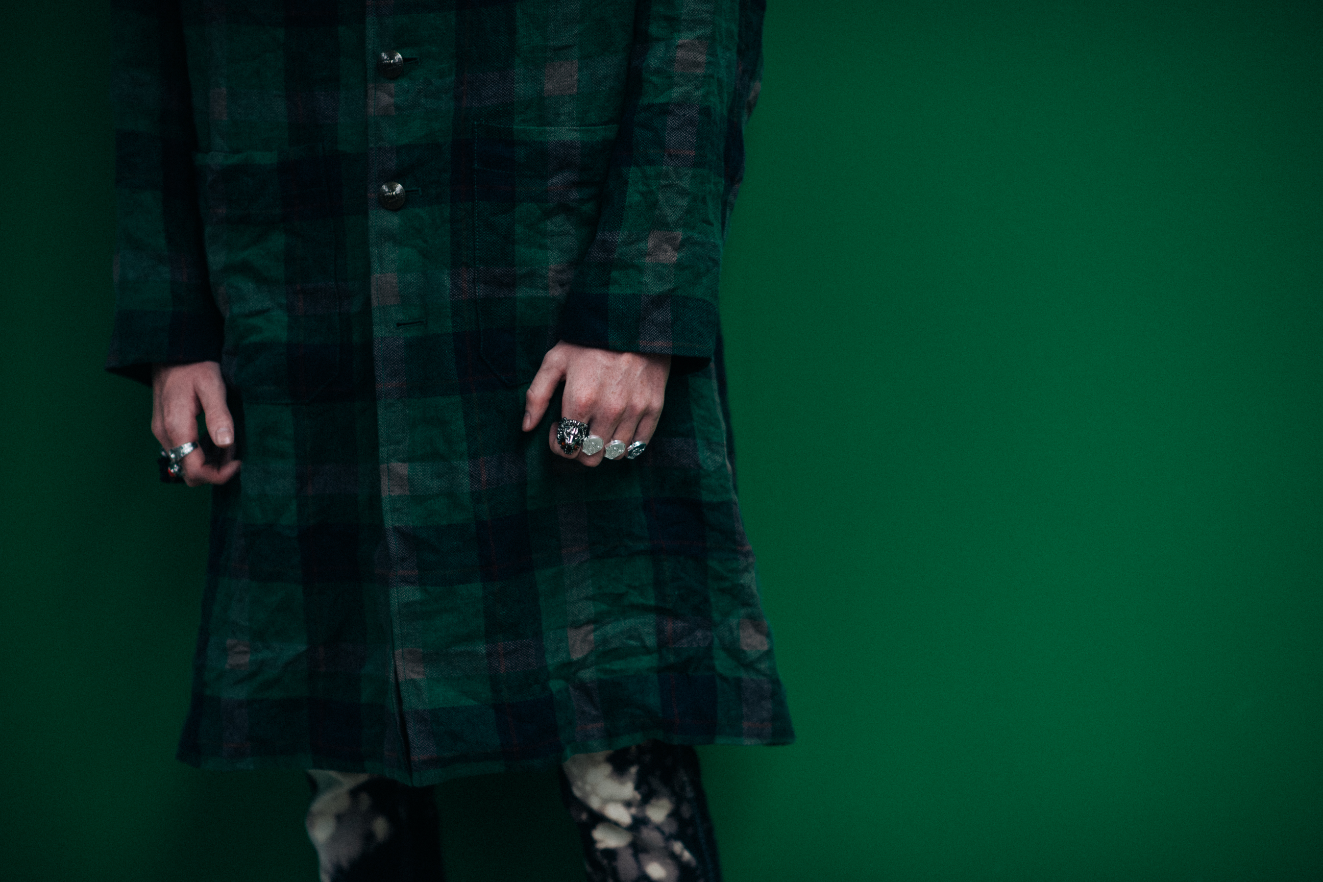 A model wearing a long green coat