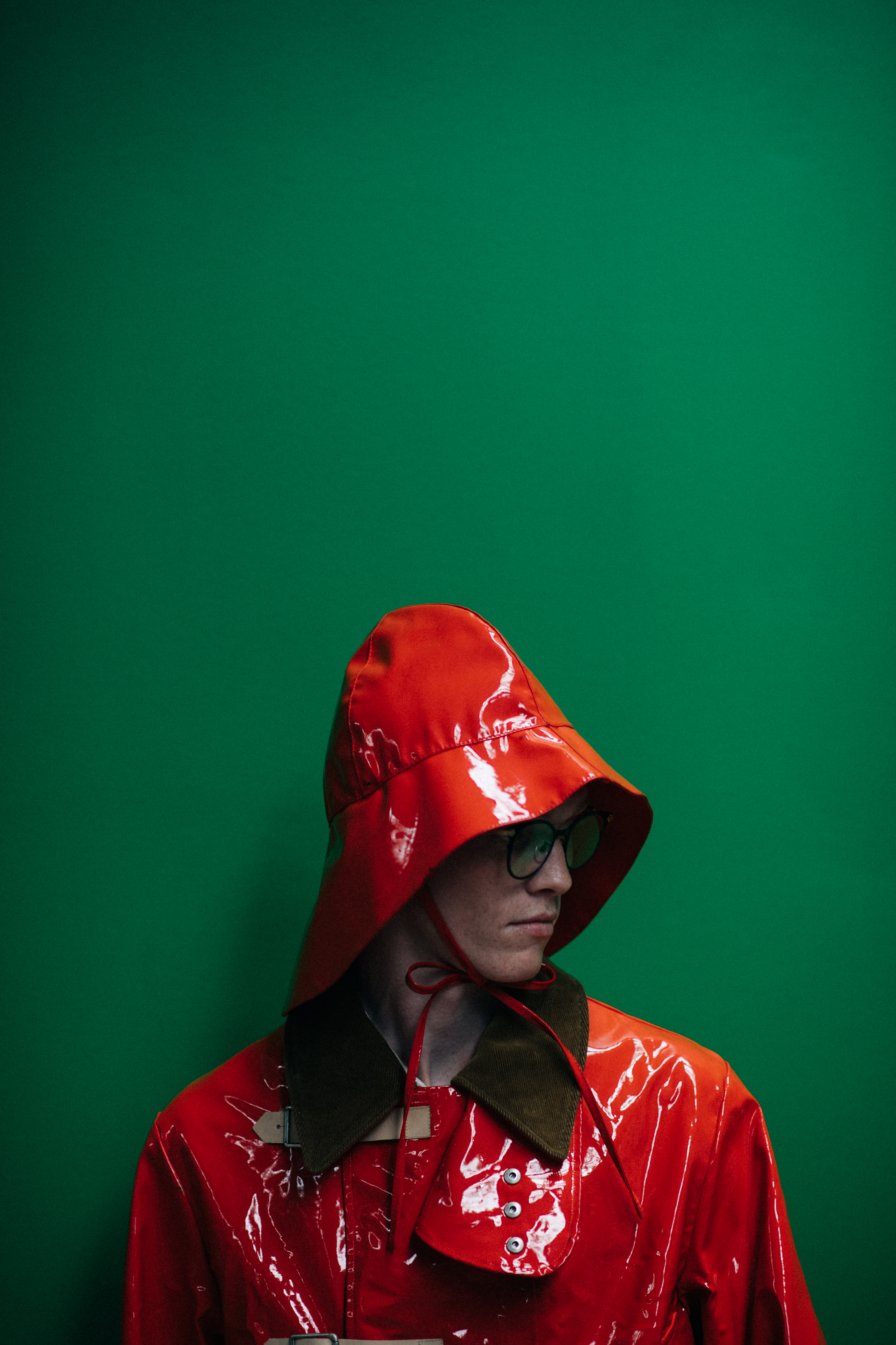 A model in a bright raincoat