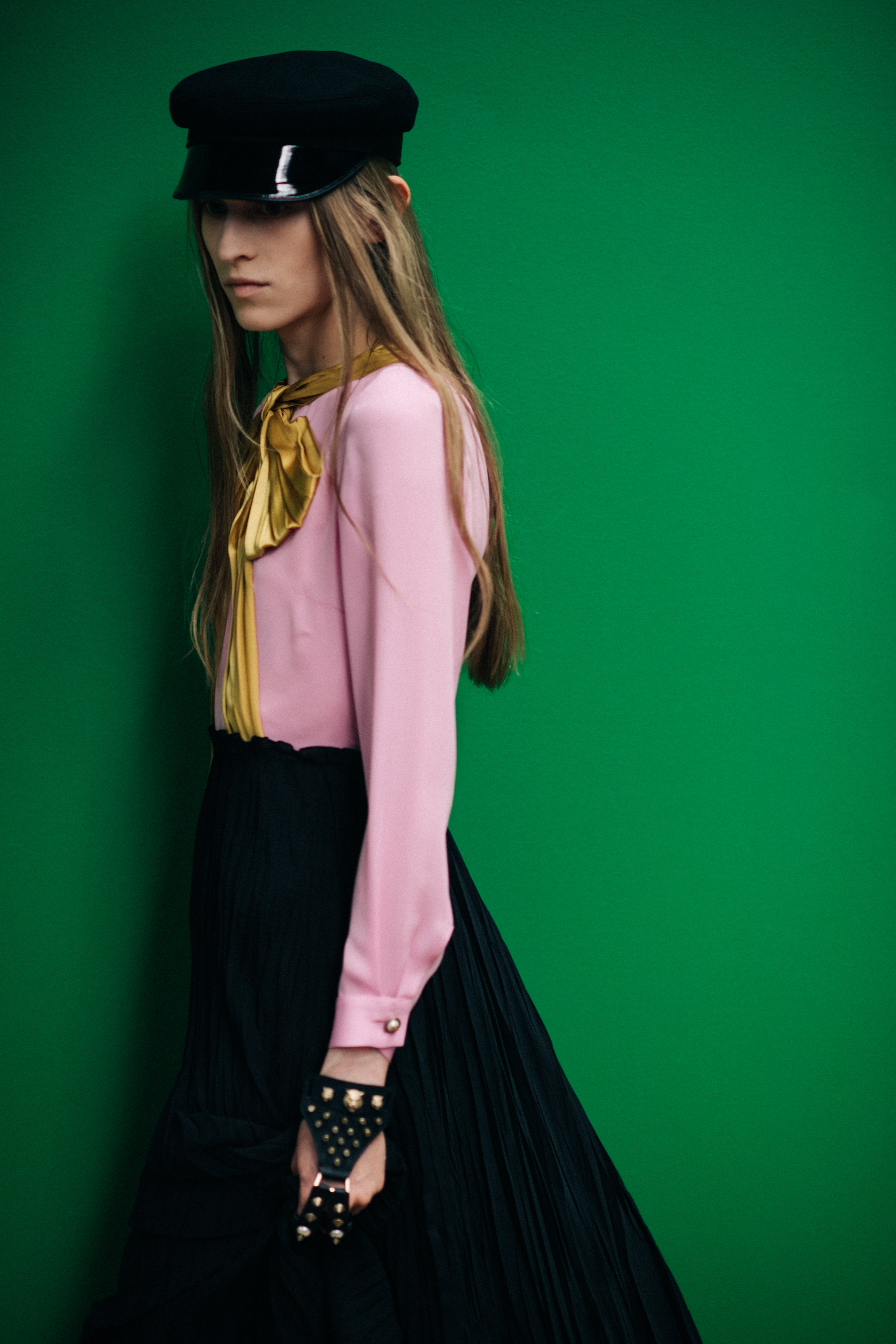 A model in a pink sweater