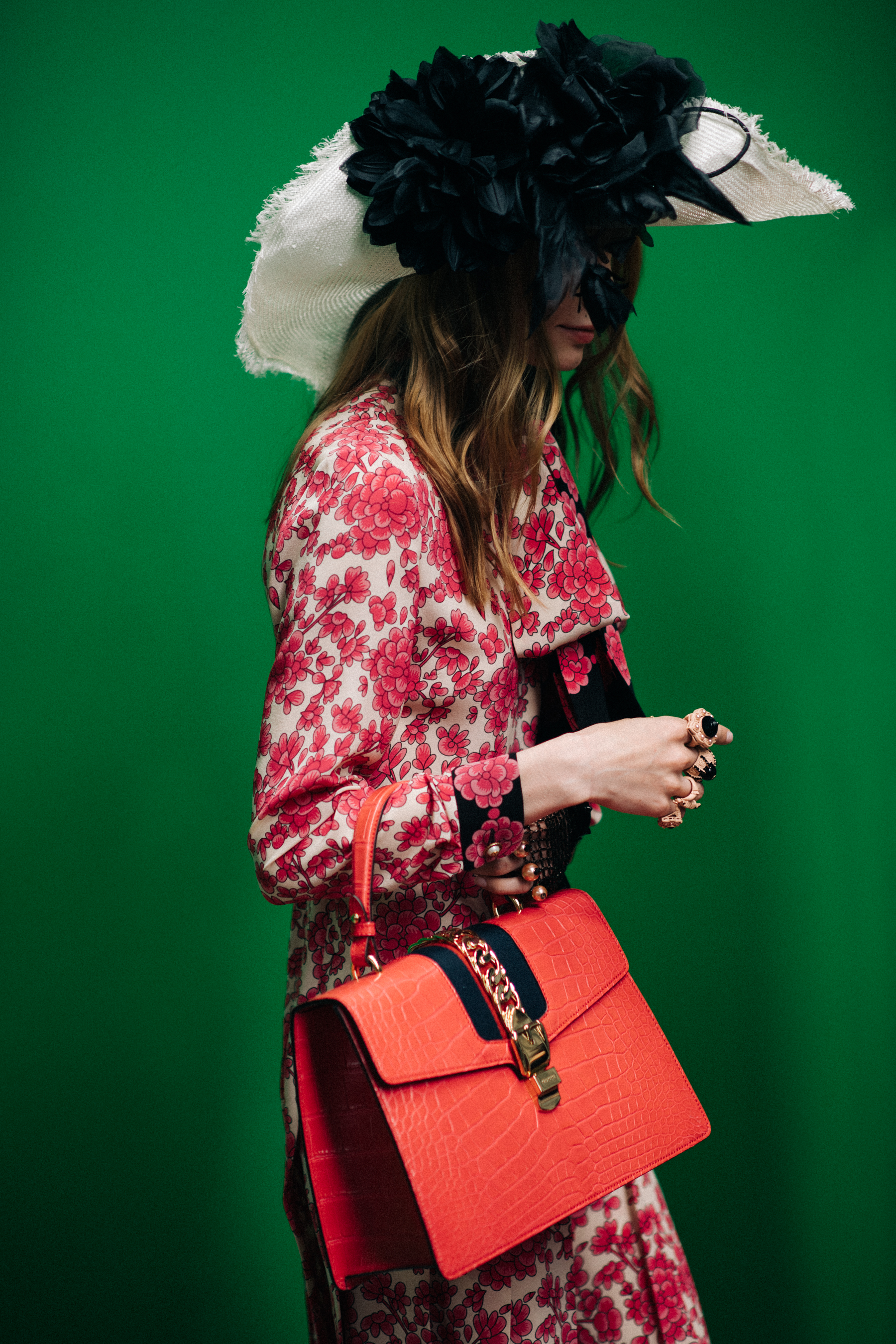 A girl in a pink dress with a bag