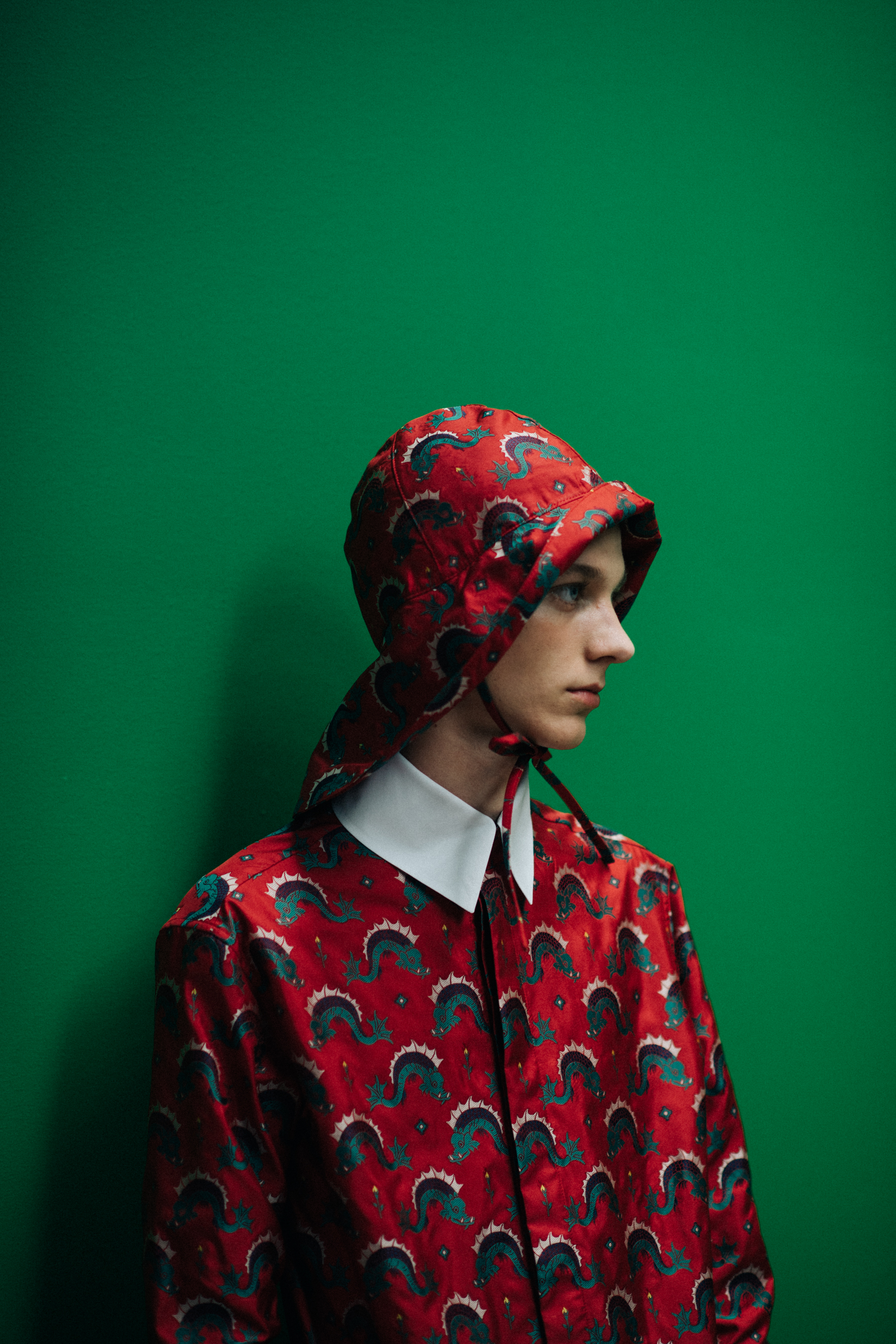A young man in a red outft