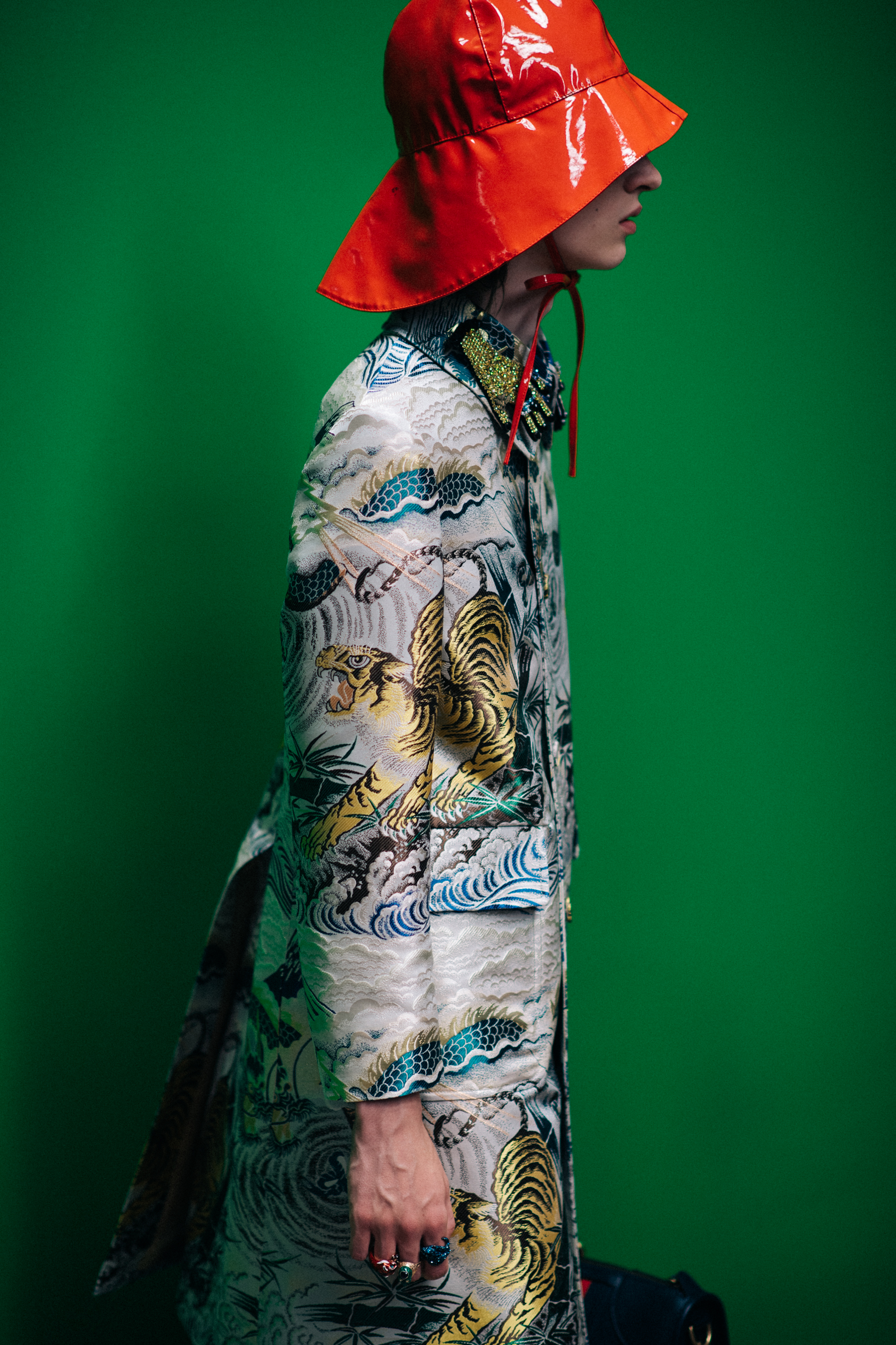 A model wearing a bright orange hat