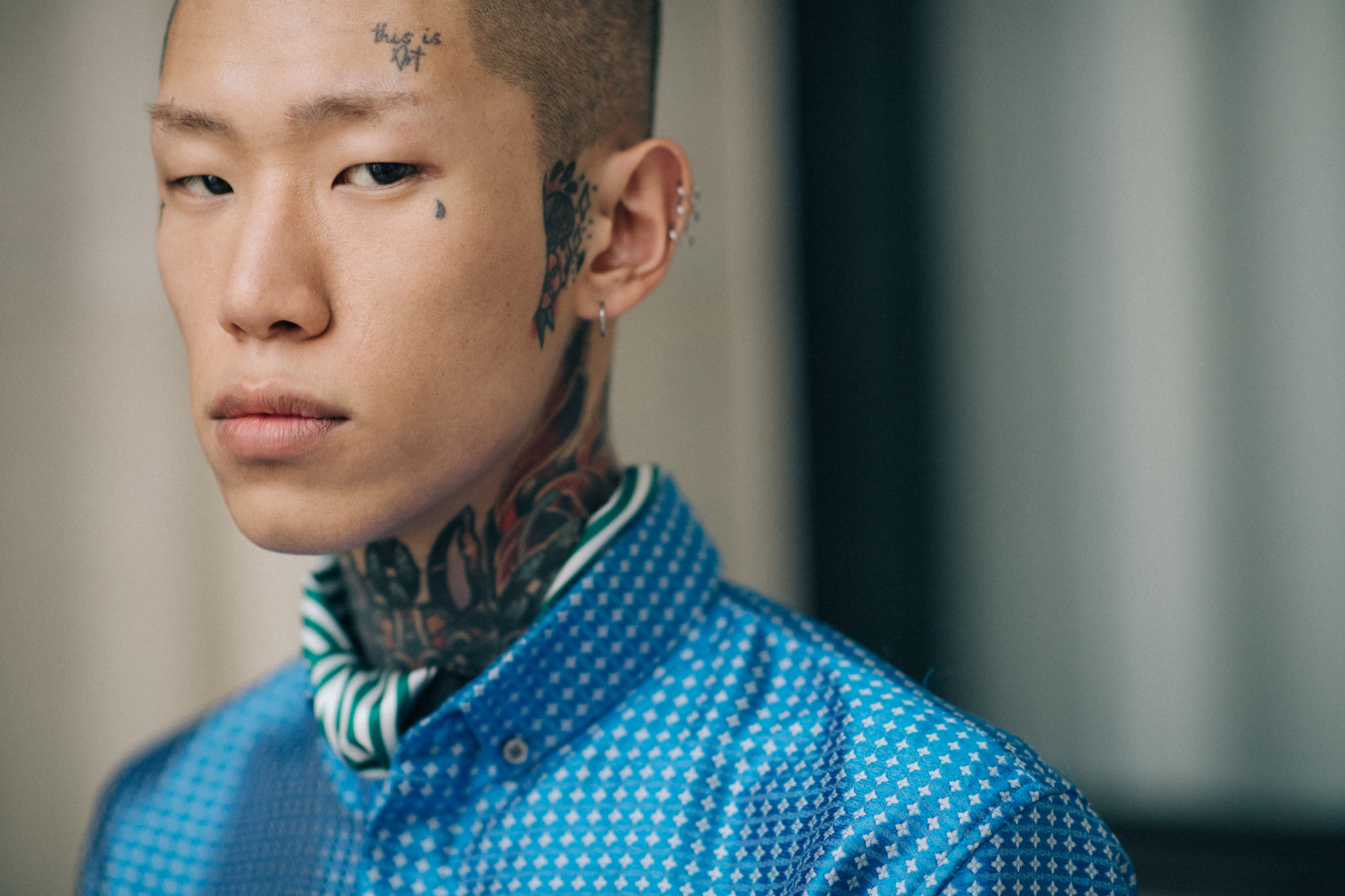 An Asian model in a blue shirt