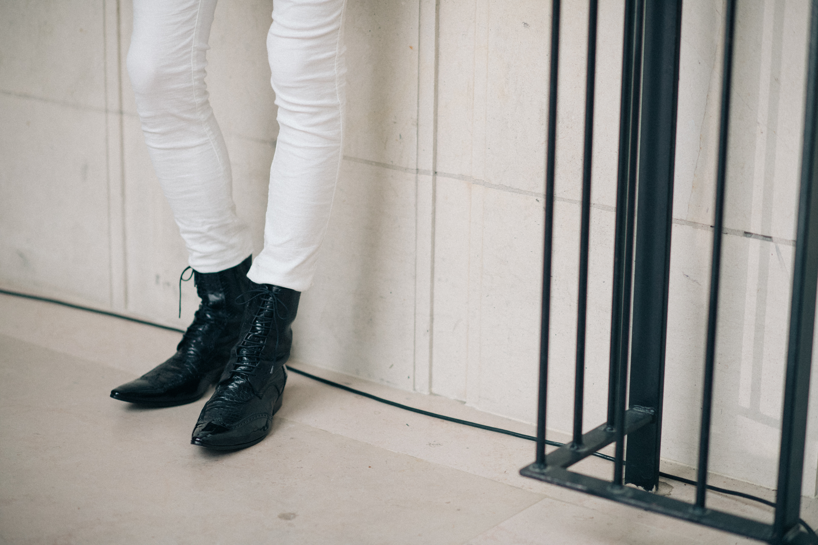 White trousers and black boots