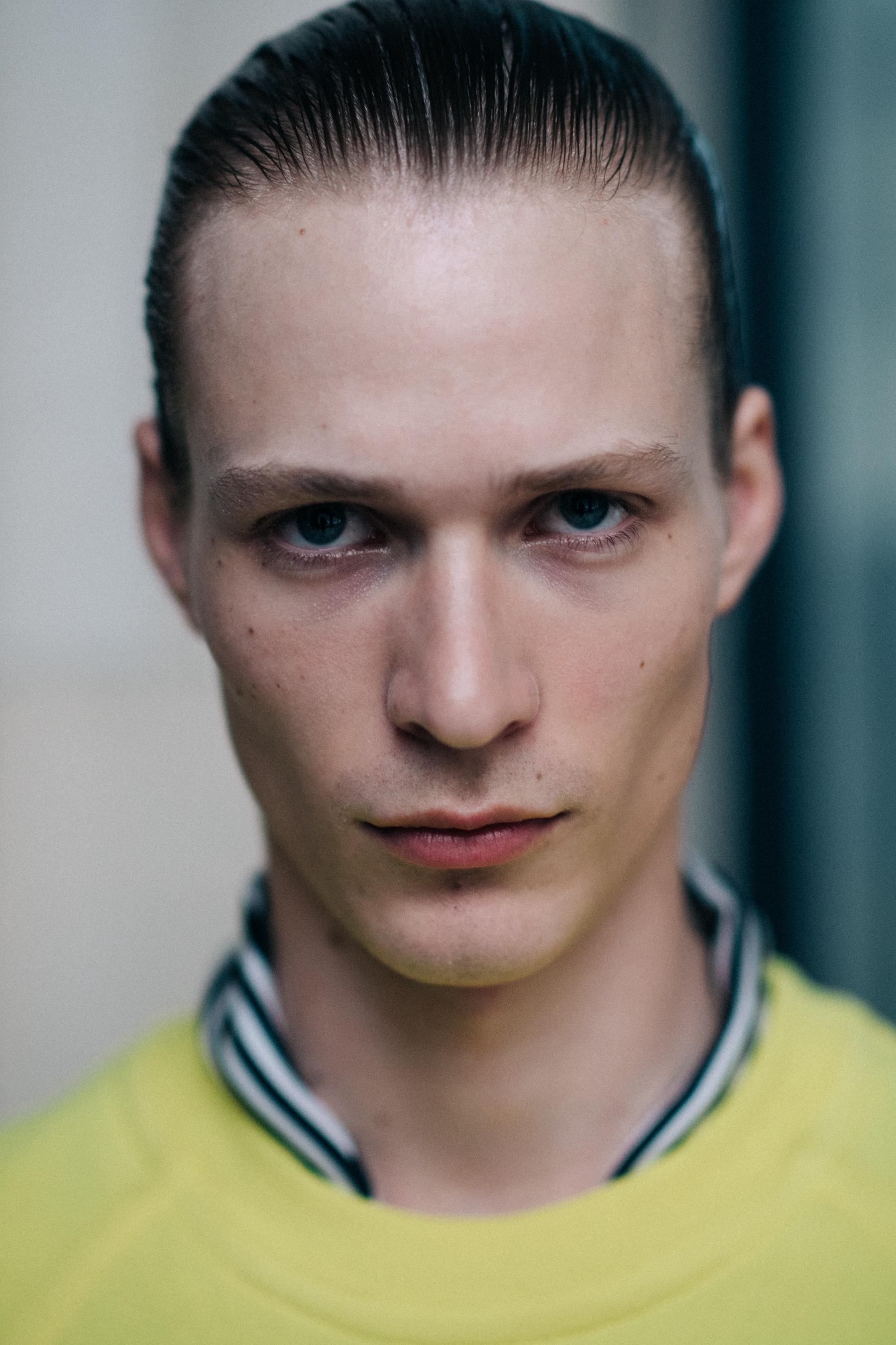 A man wearing a yellow sweater