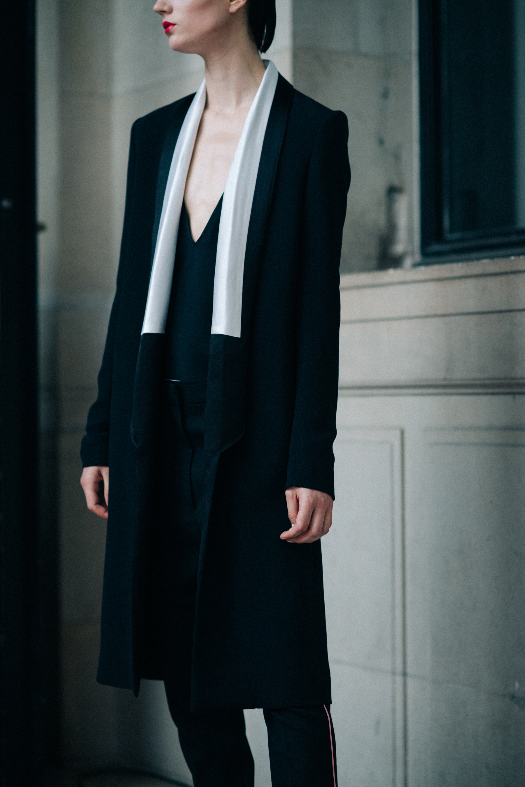 A model wearing a long black coat