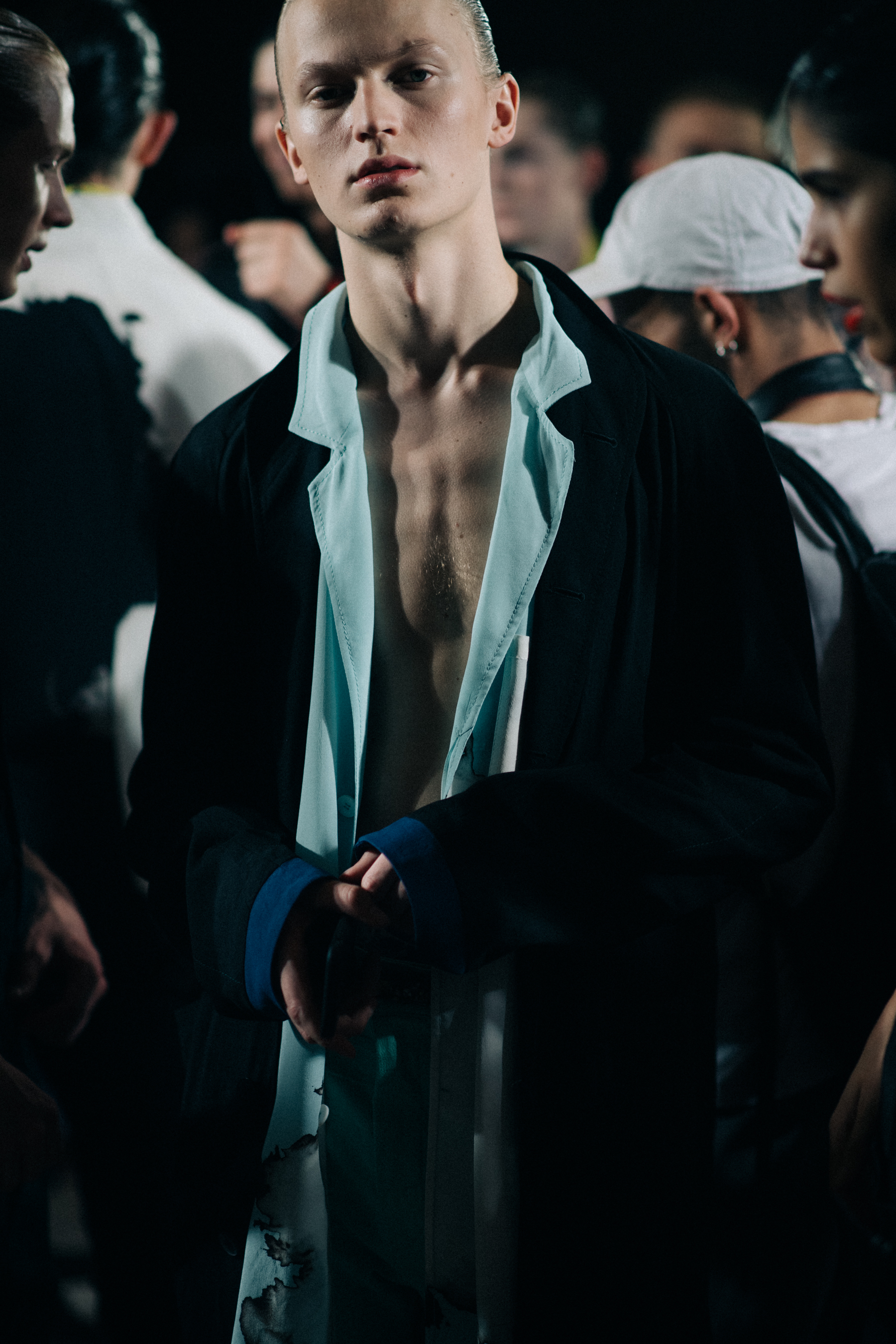 A young man in a shirt an a jacket