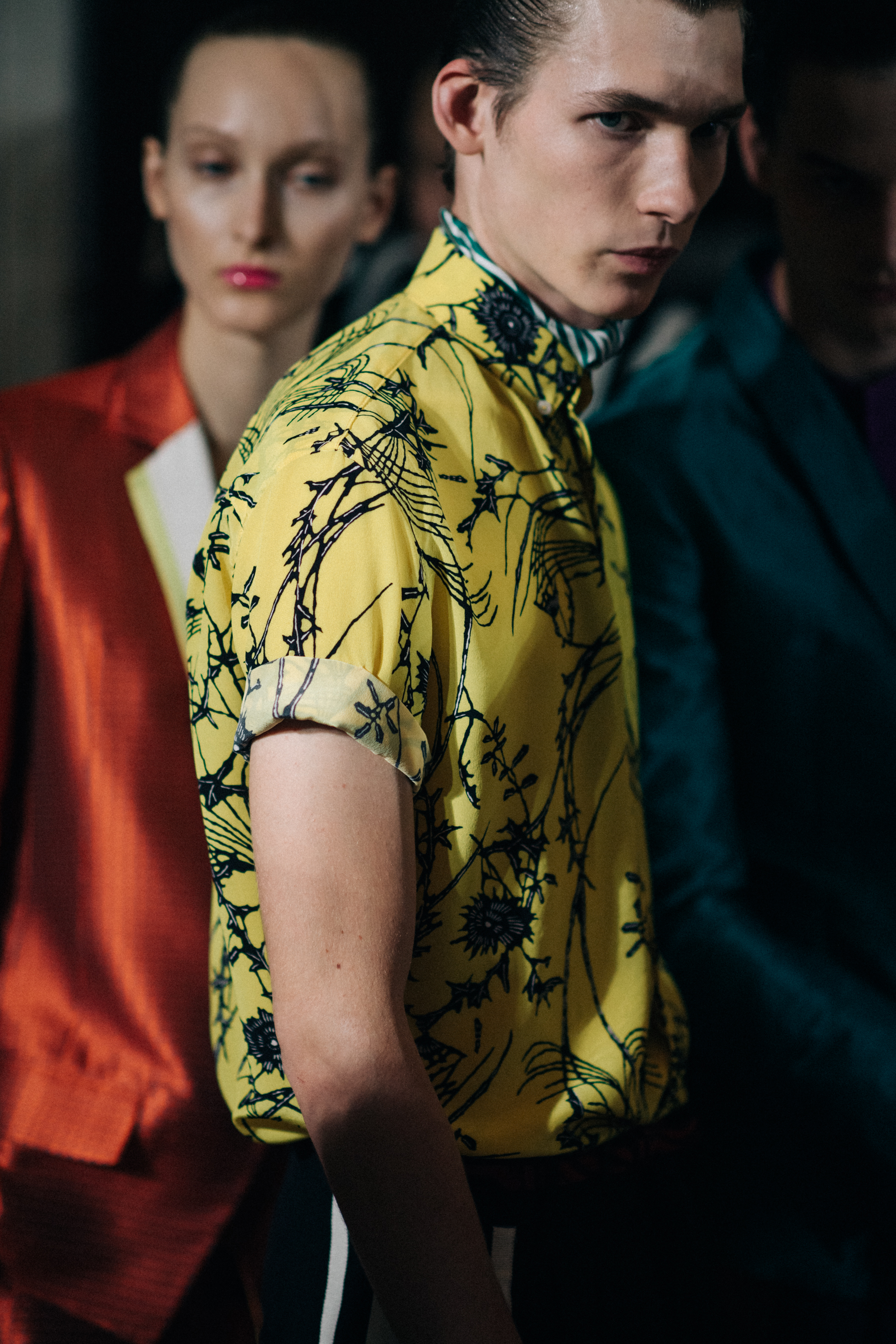 A male model in a yellow shirt