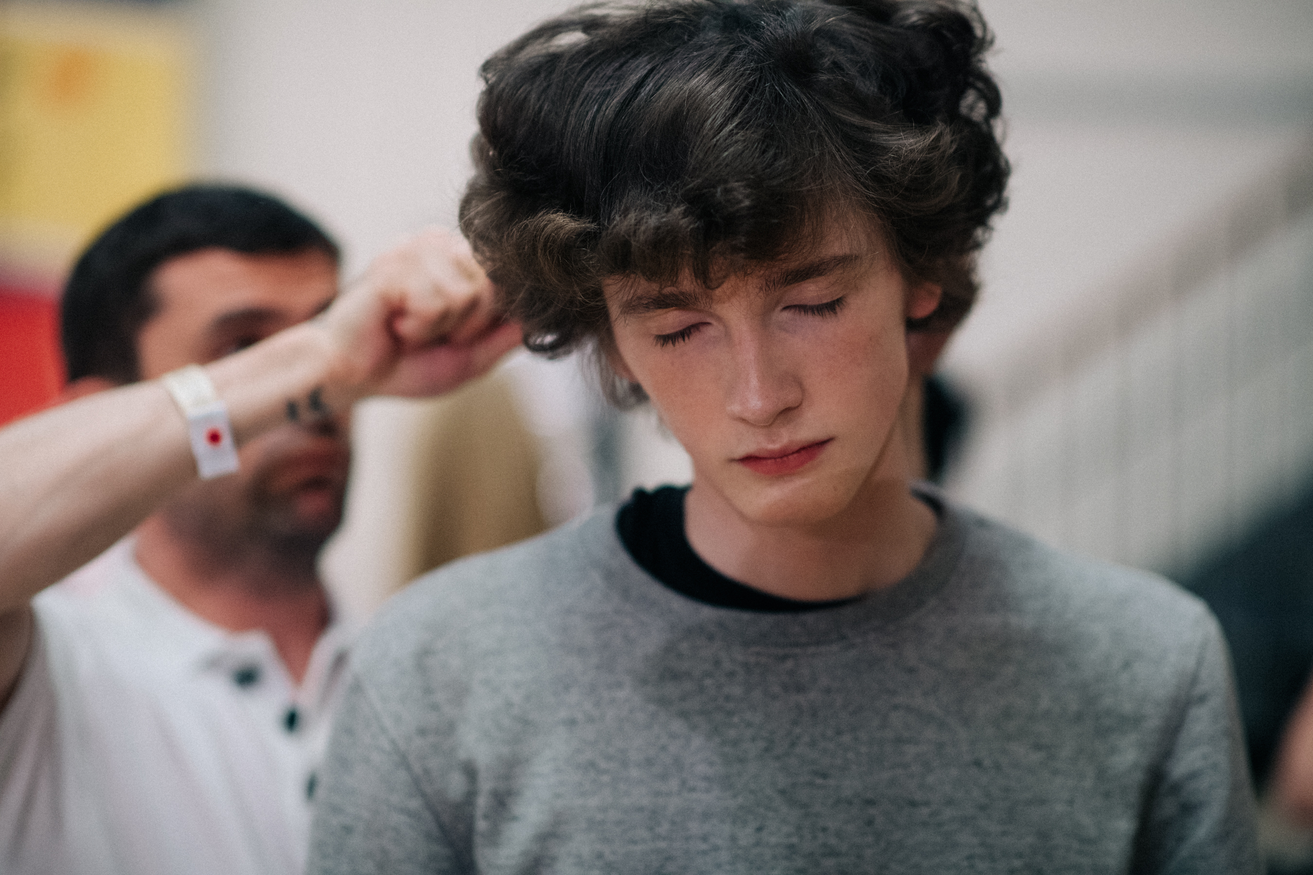 Curly-haired model getting ready