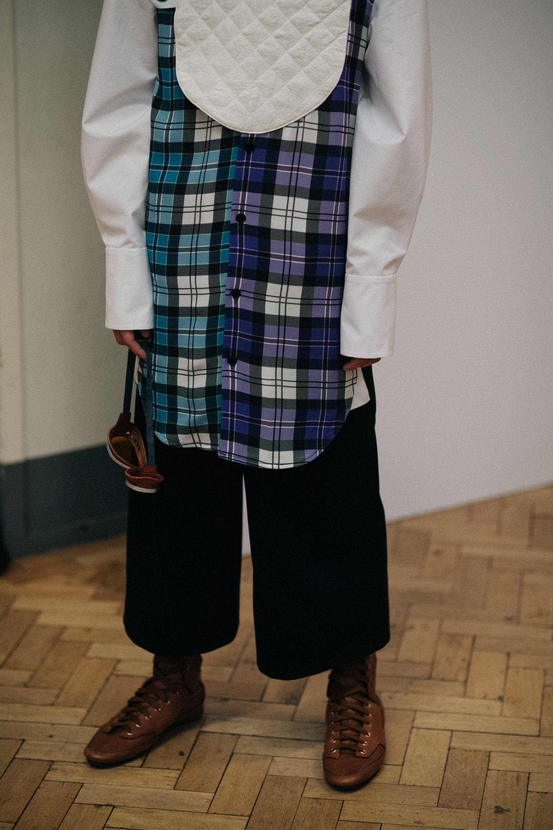 Model in black trousers, white shirt