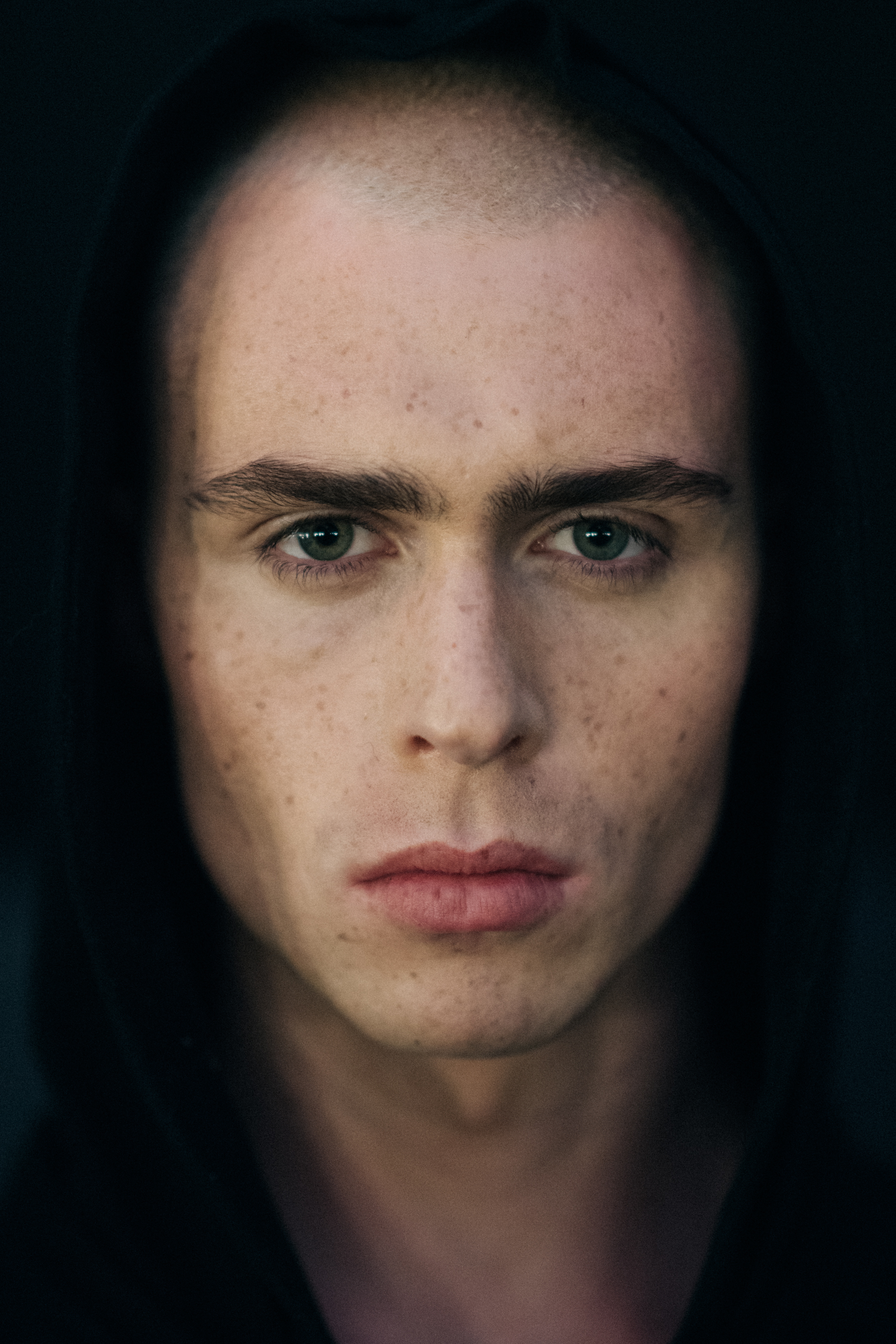 Portrait of a model in a black hoodie