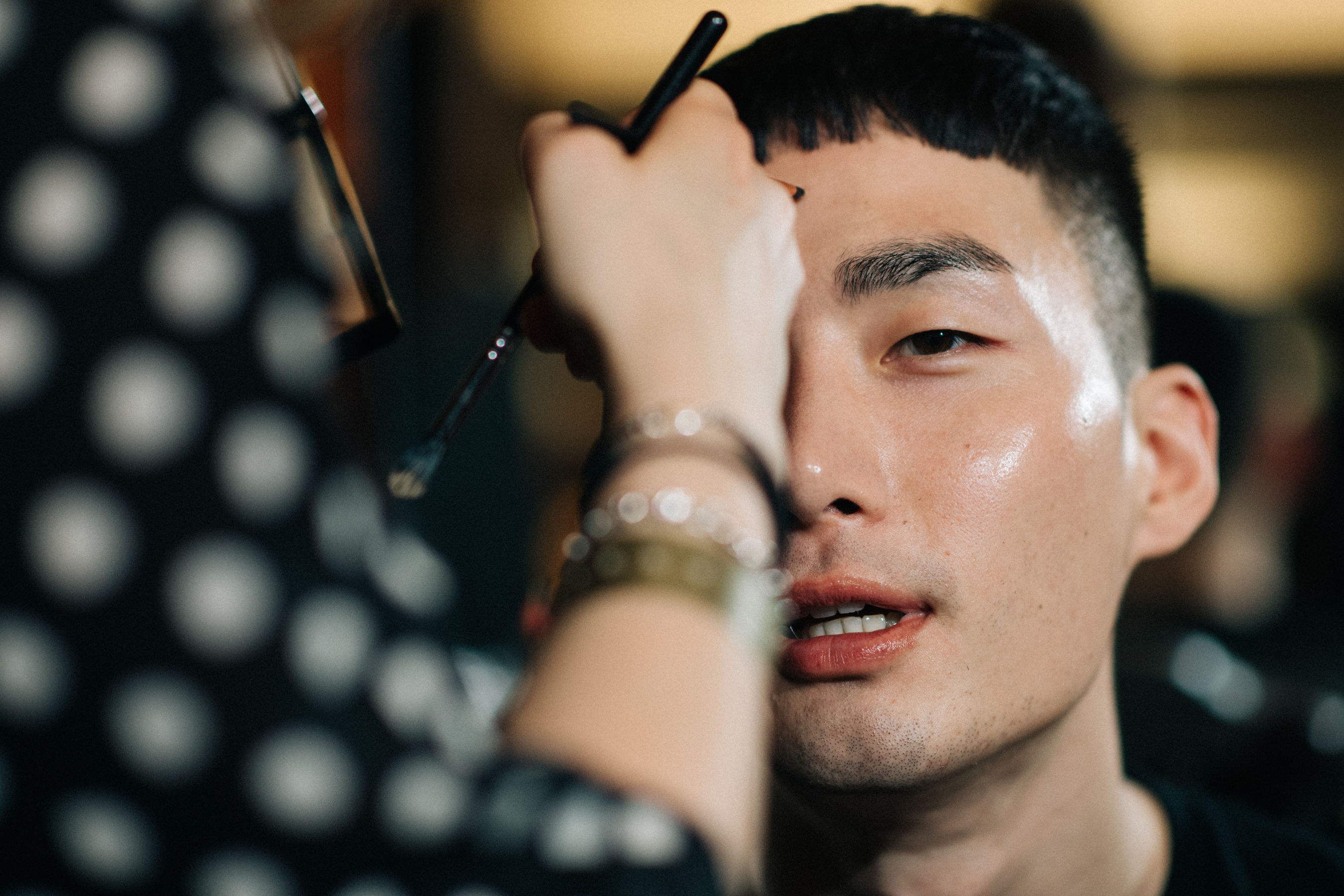 Male model getting make-up done