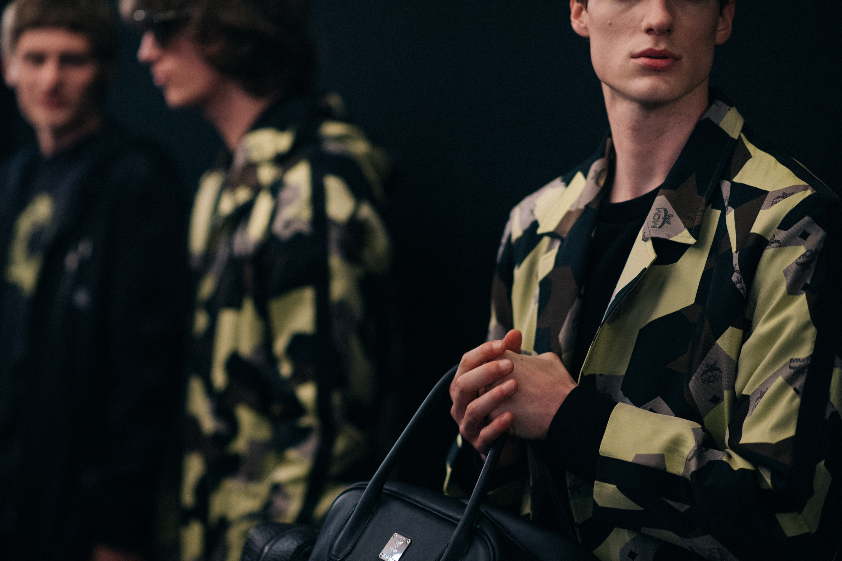 Male models in printed jackets posing