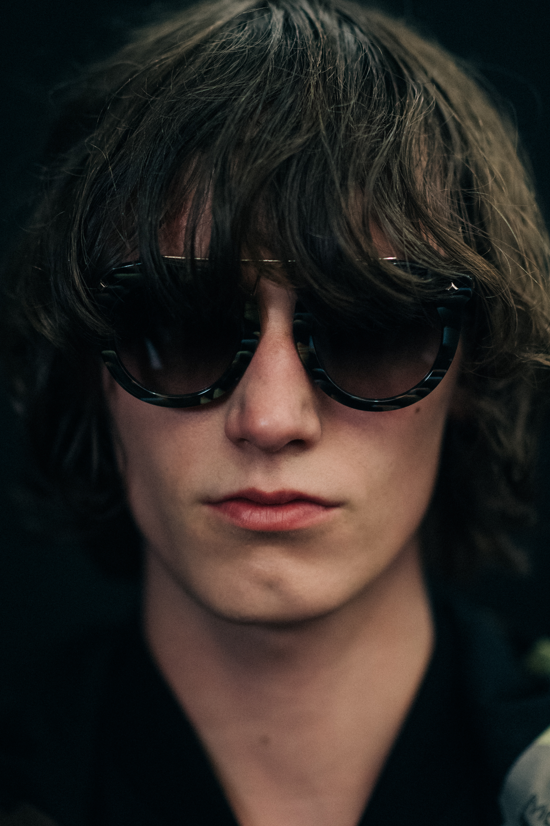 Male model with long hair in sunglasses