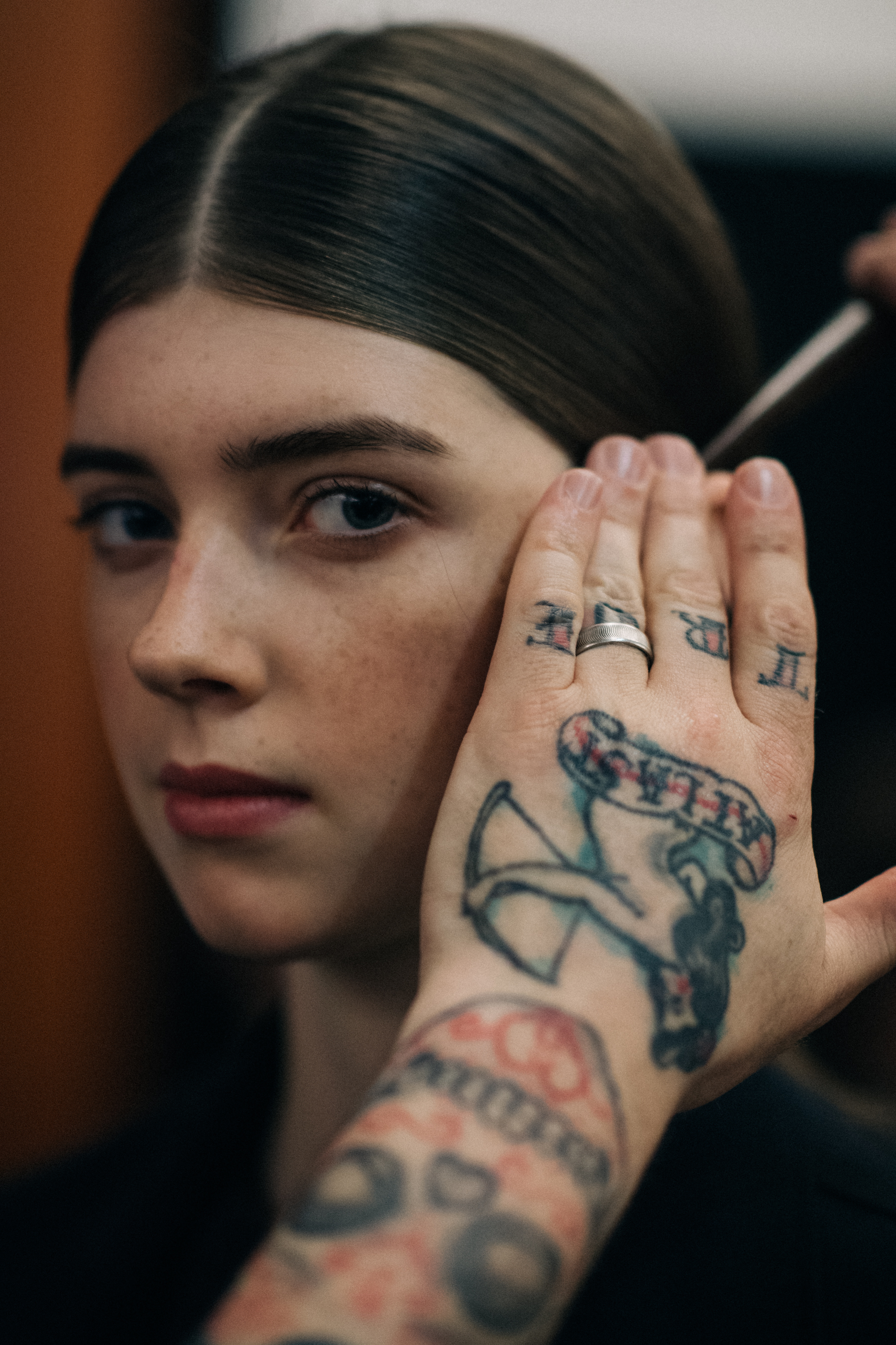 Tattoed hand of a make-up artist