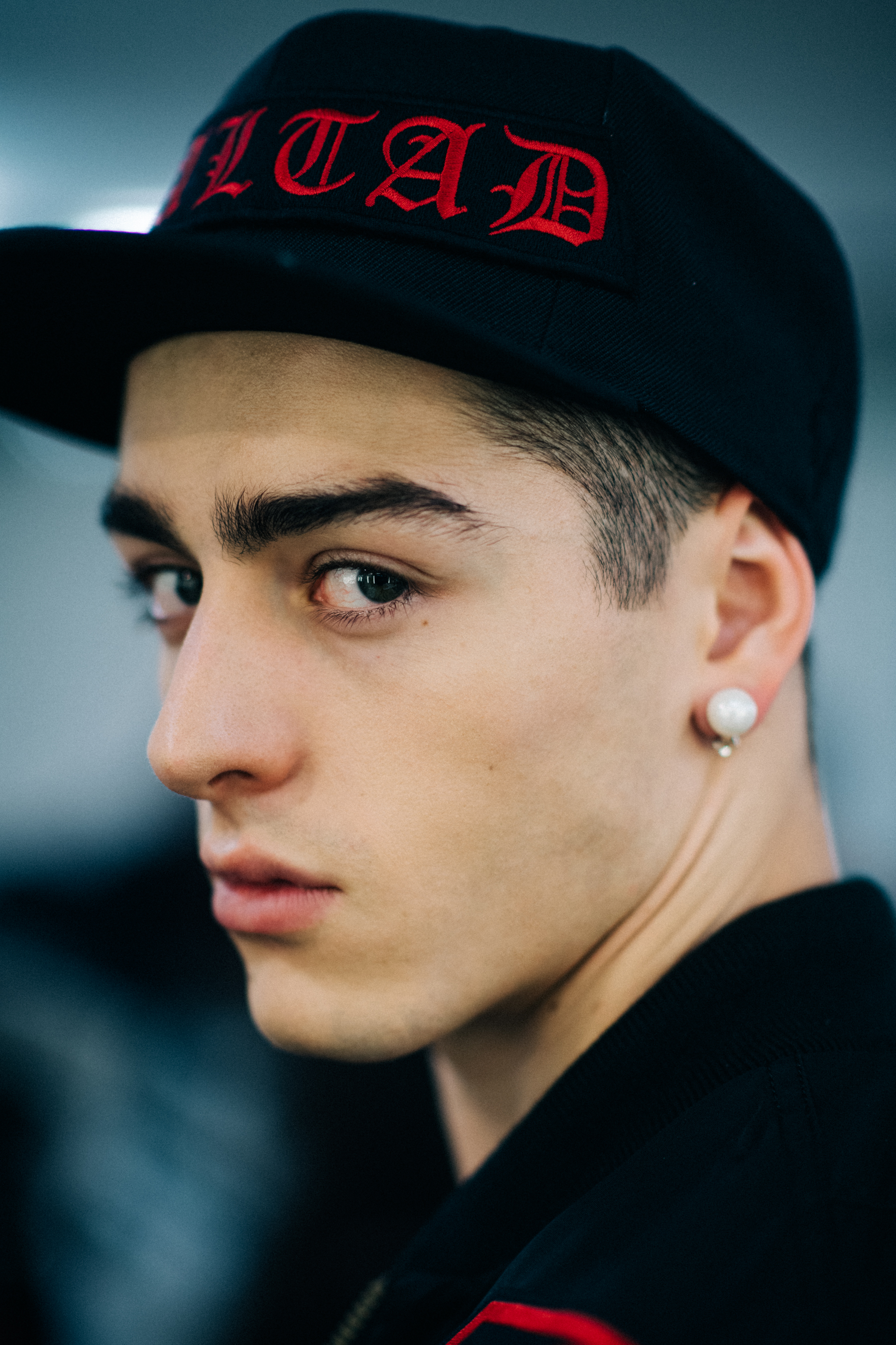 Male model in a cap with earrings