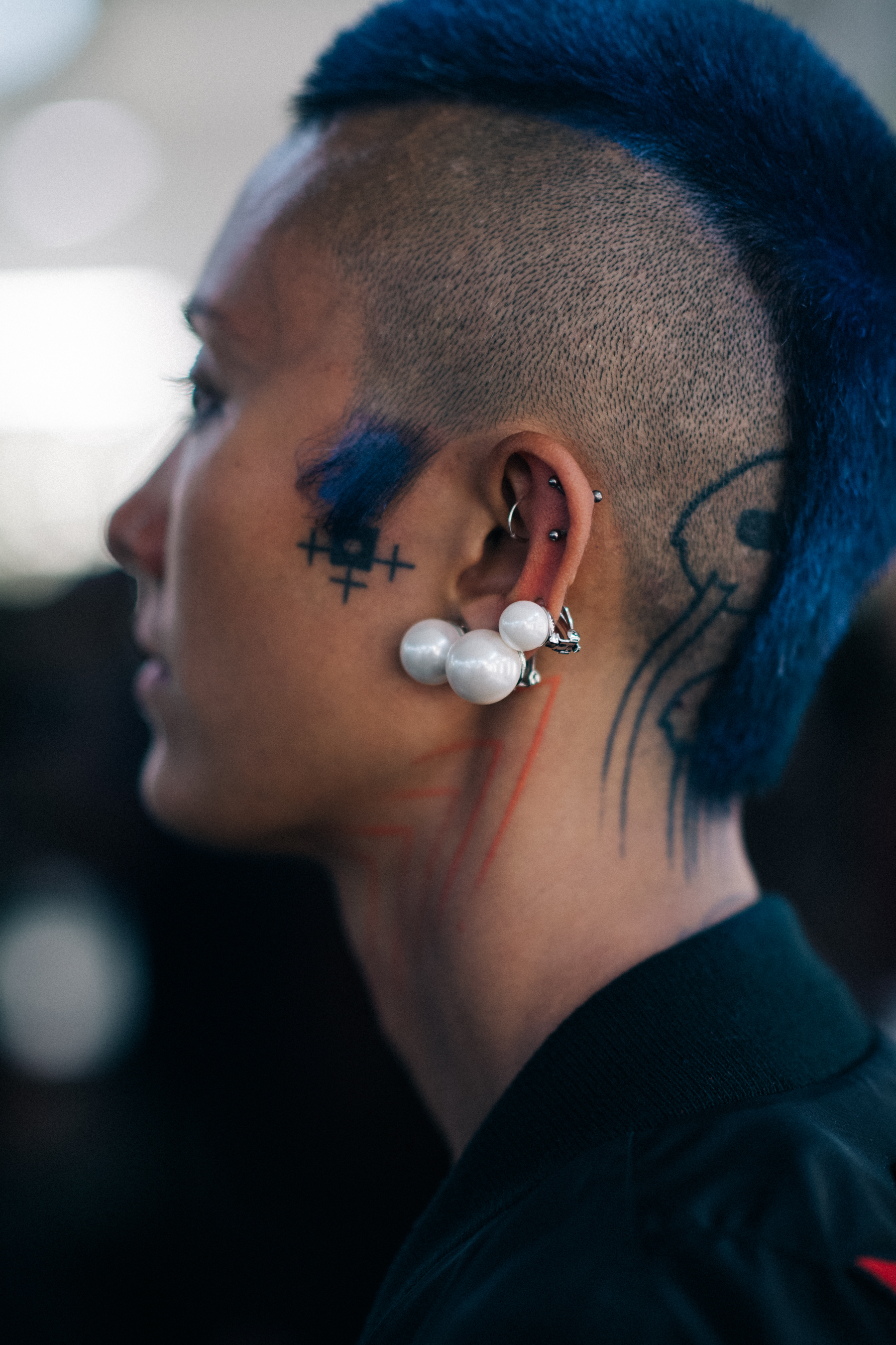 A tattoed woman with accessories