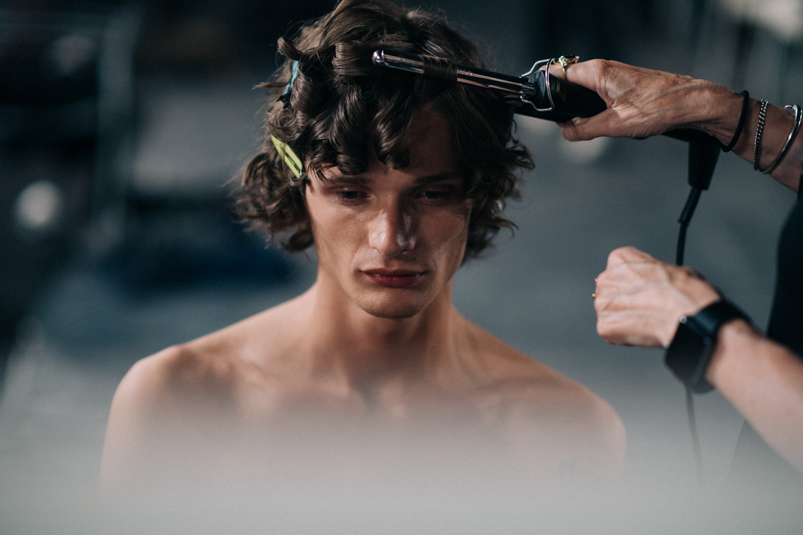 A model getting his hair done