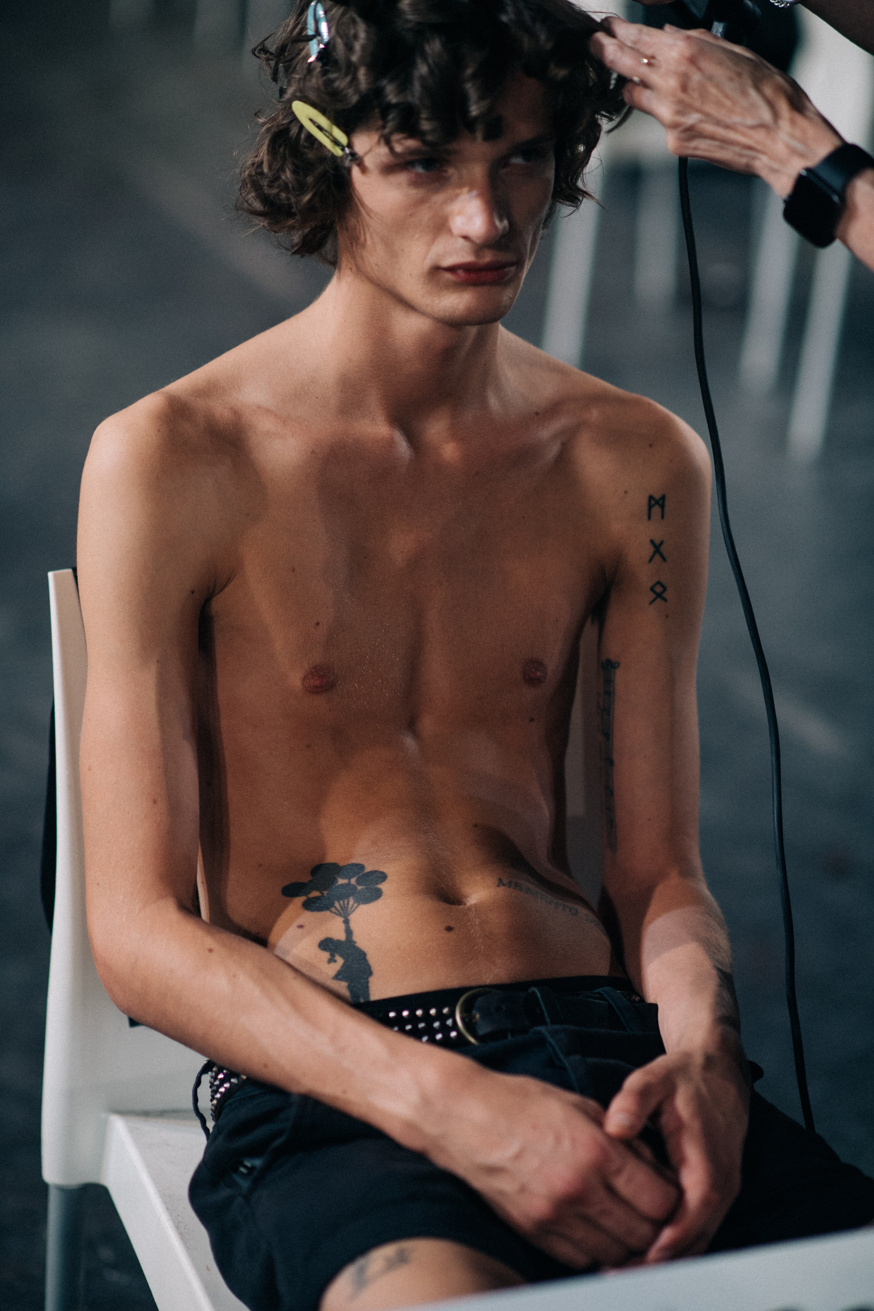 A male model hanging out backstage