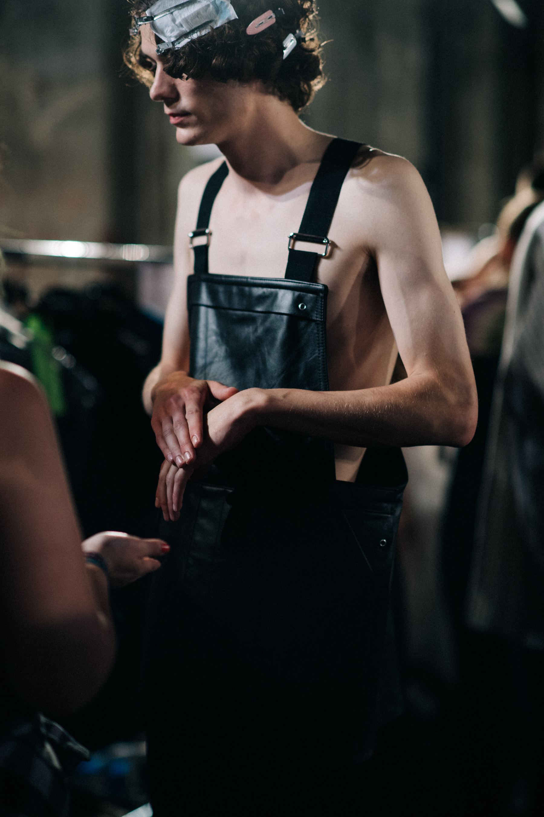 Male model putting dungarees on