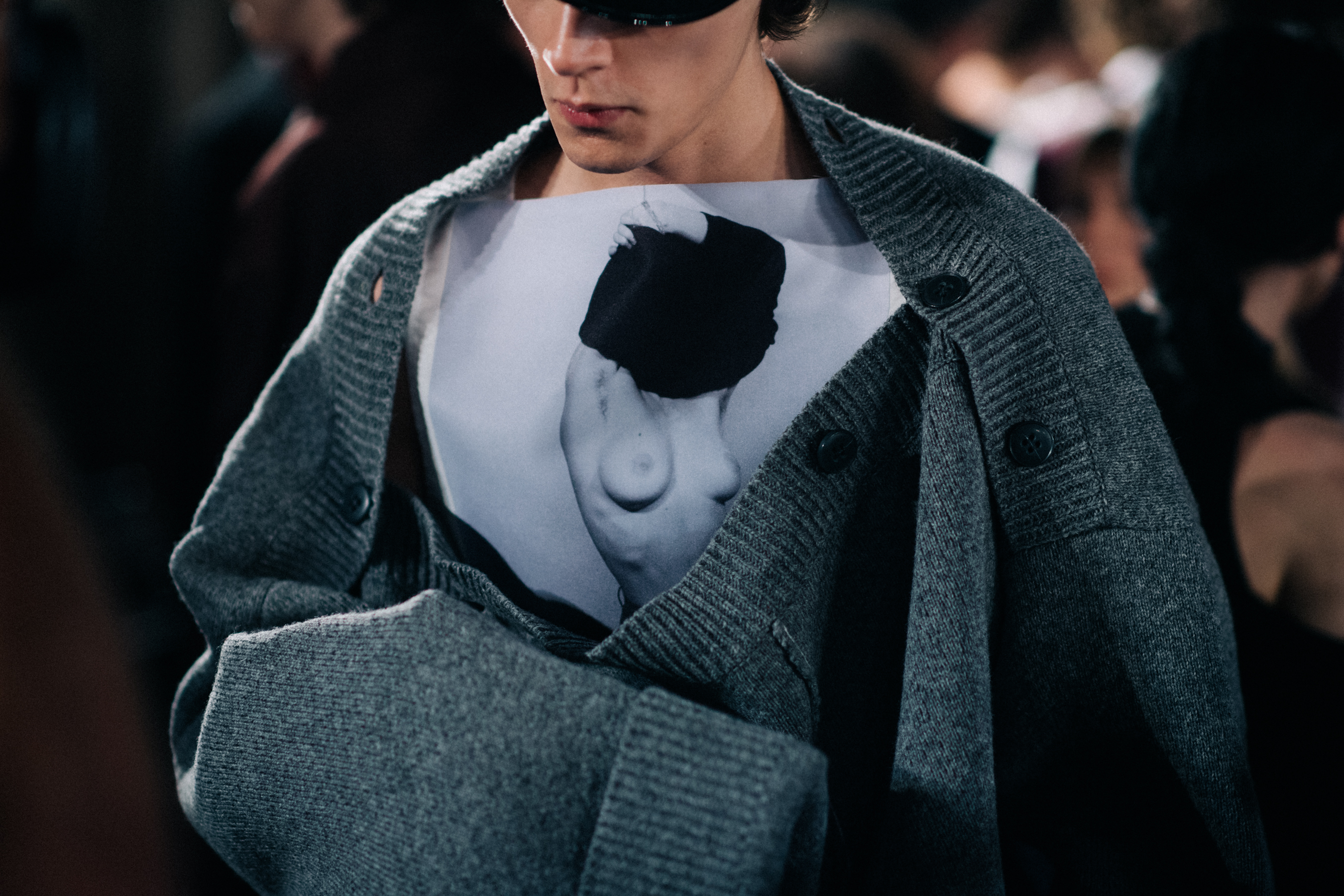 A model wearing a grey sweater