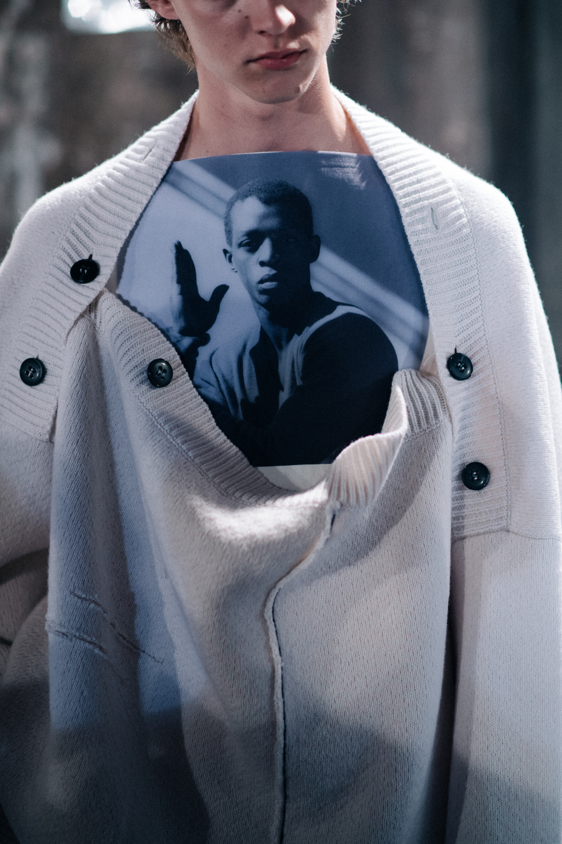 White sweater worn over a printed top