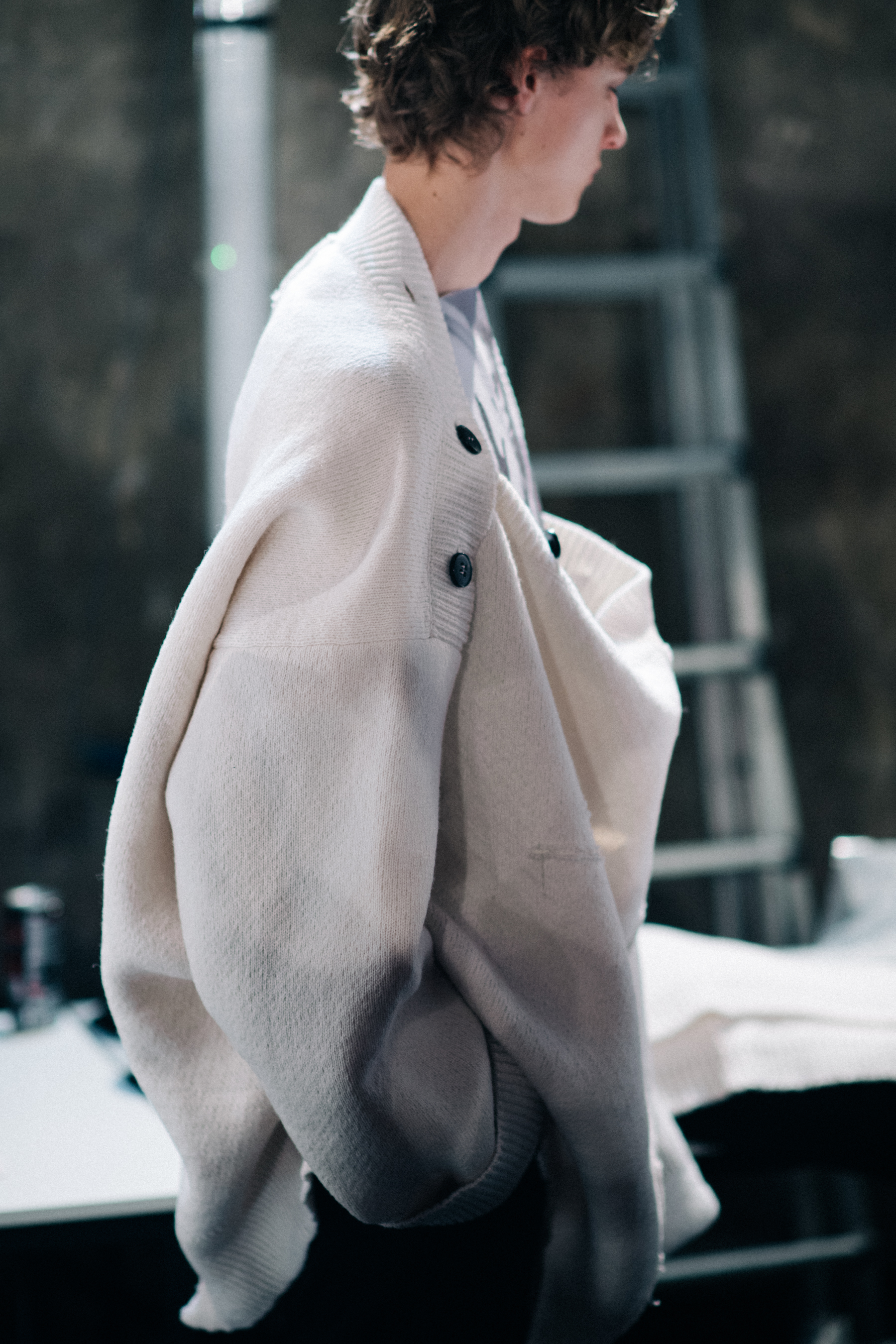A model wearing a white oversize sweater