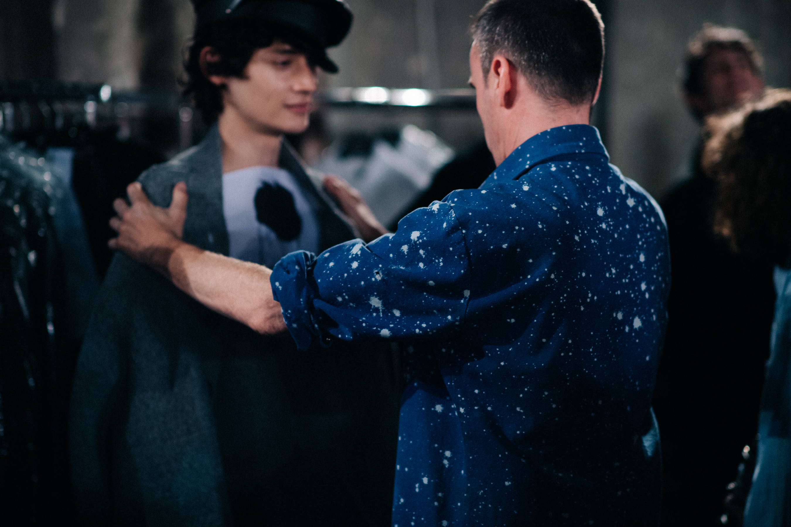 Male model being prepared by the designer