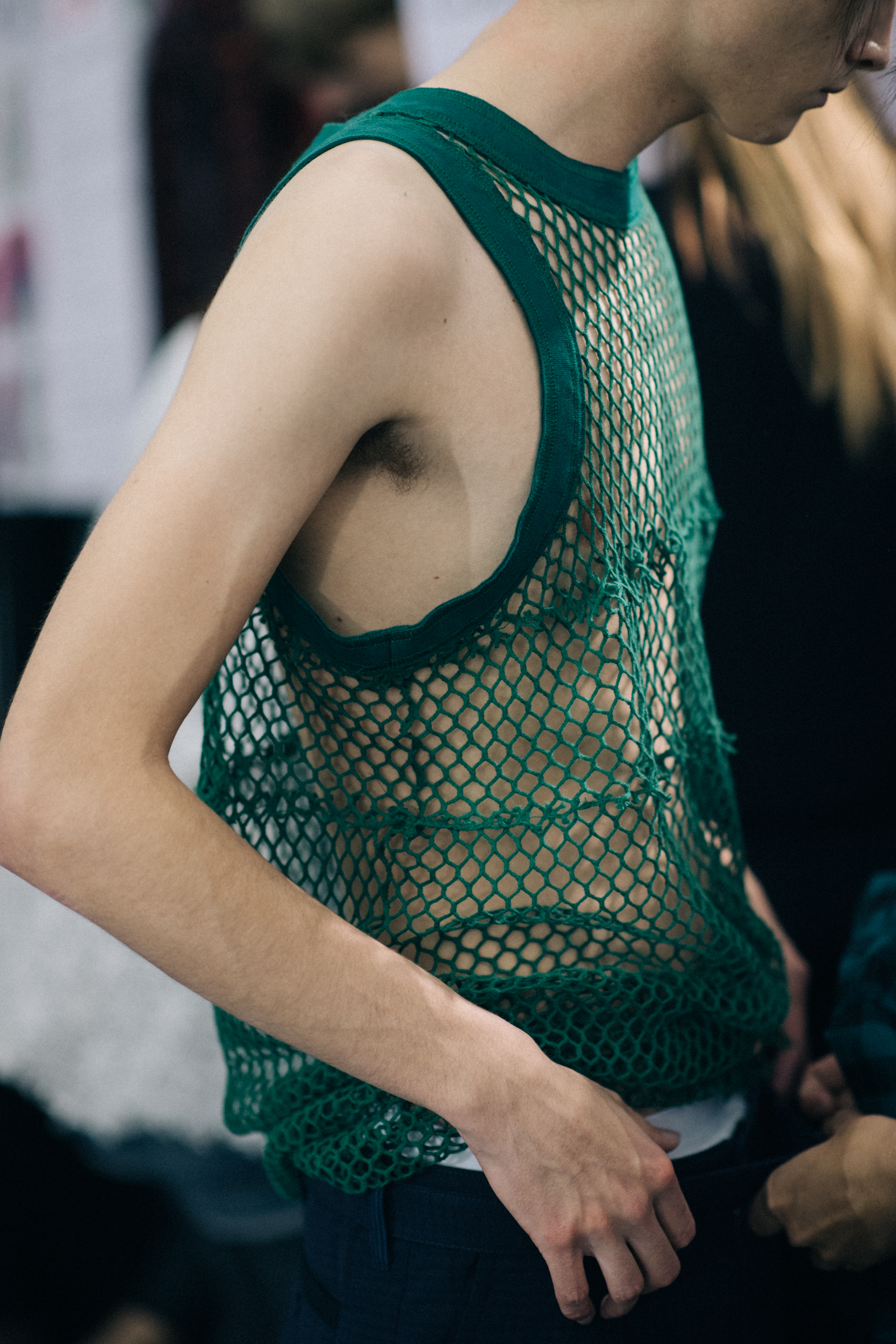 Male model wearing green vest