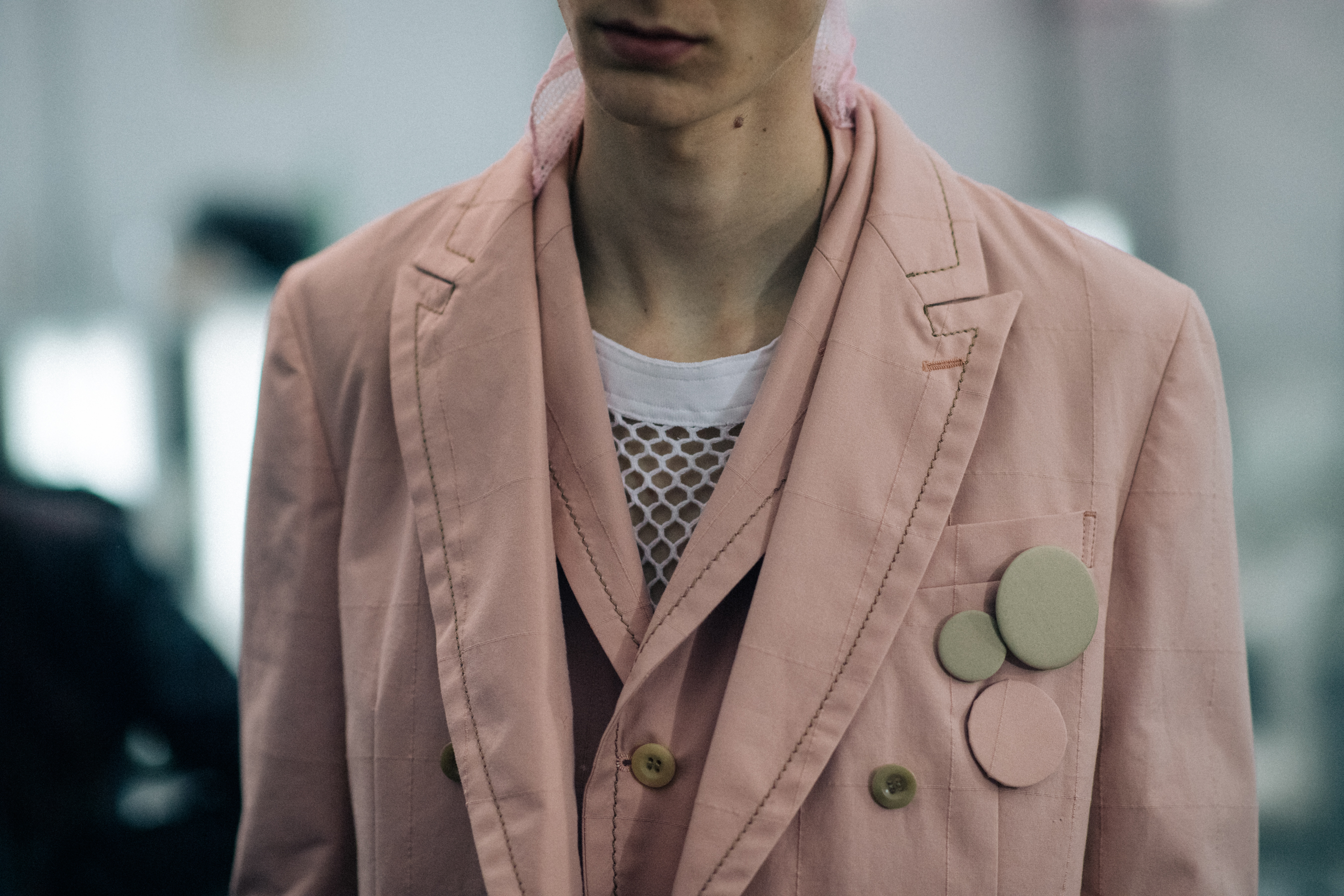 Model wearing pastel pink jacket