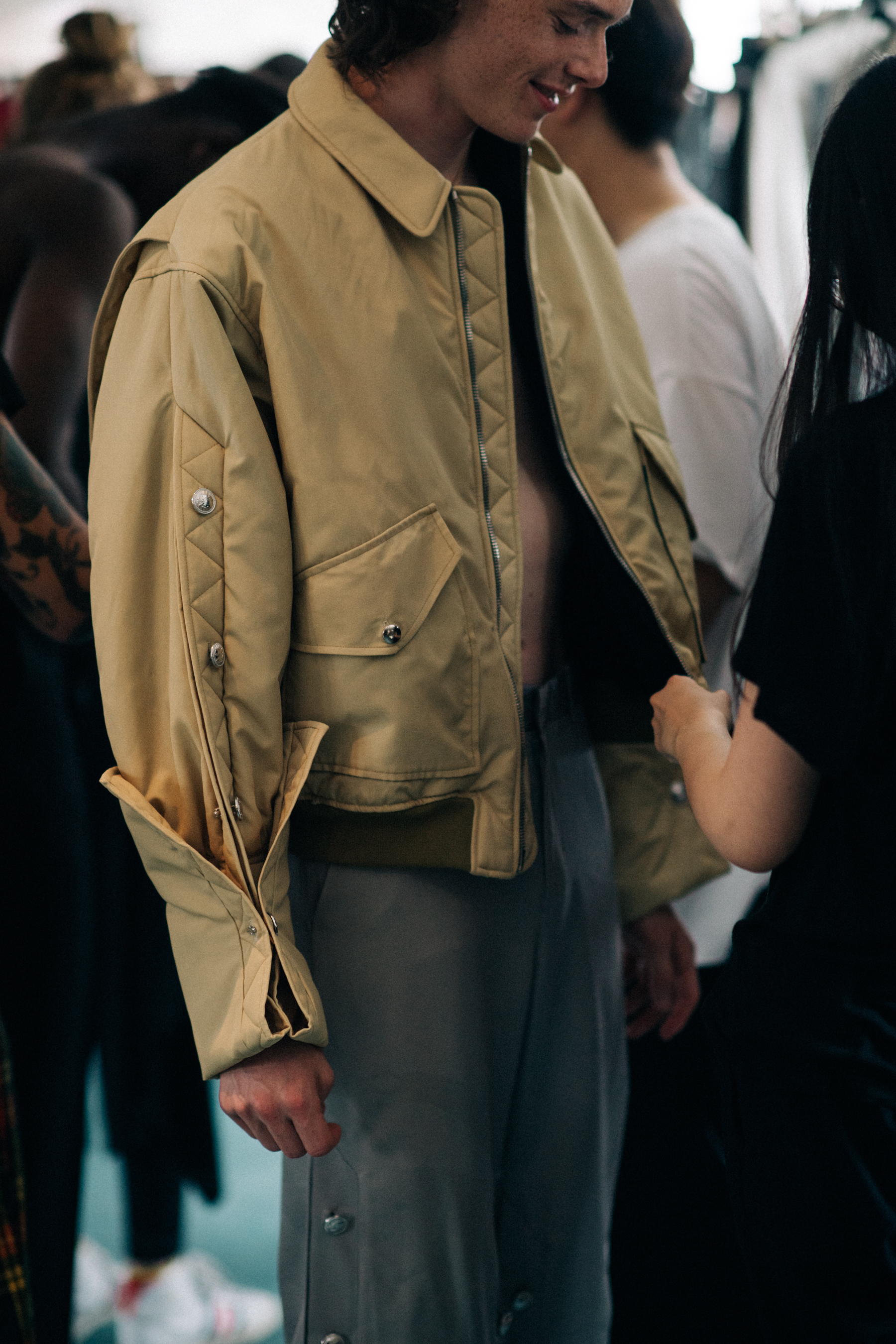 A man wearing a beige jacket