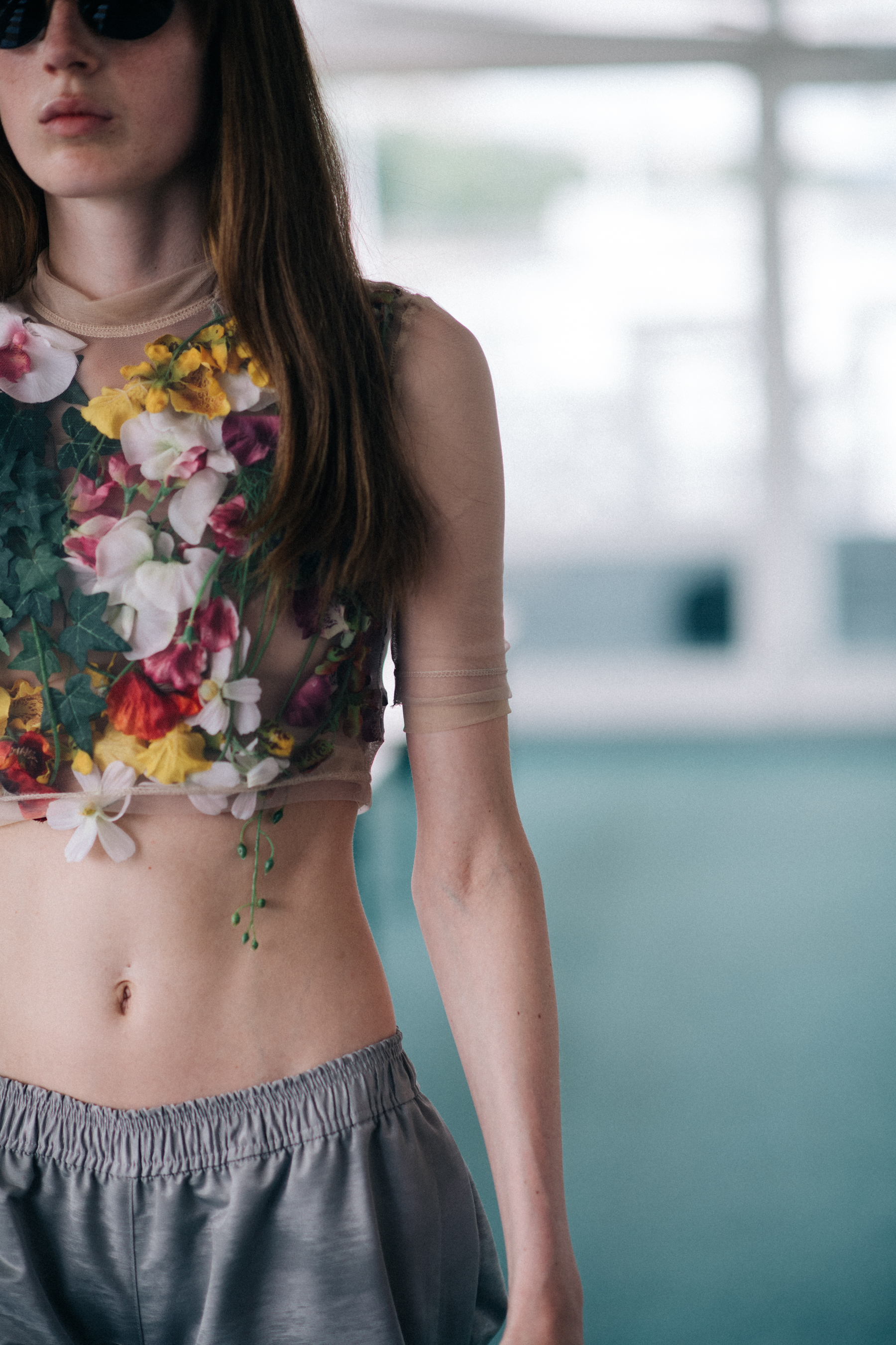 A model wearing a top with flowers