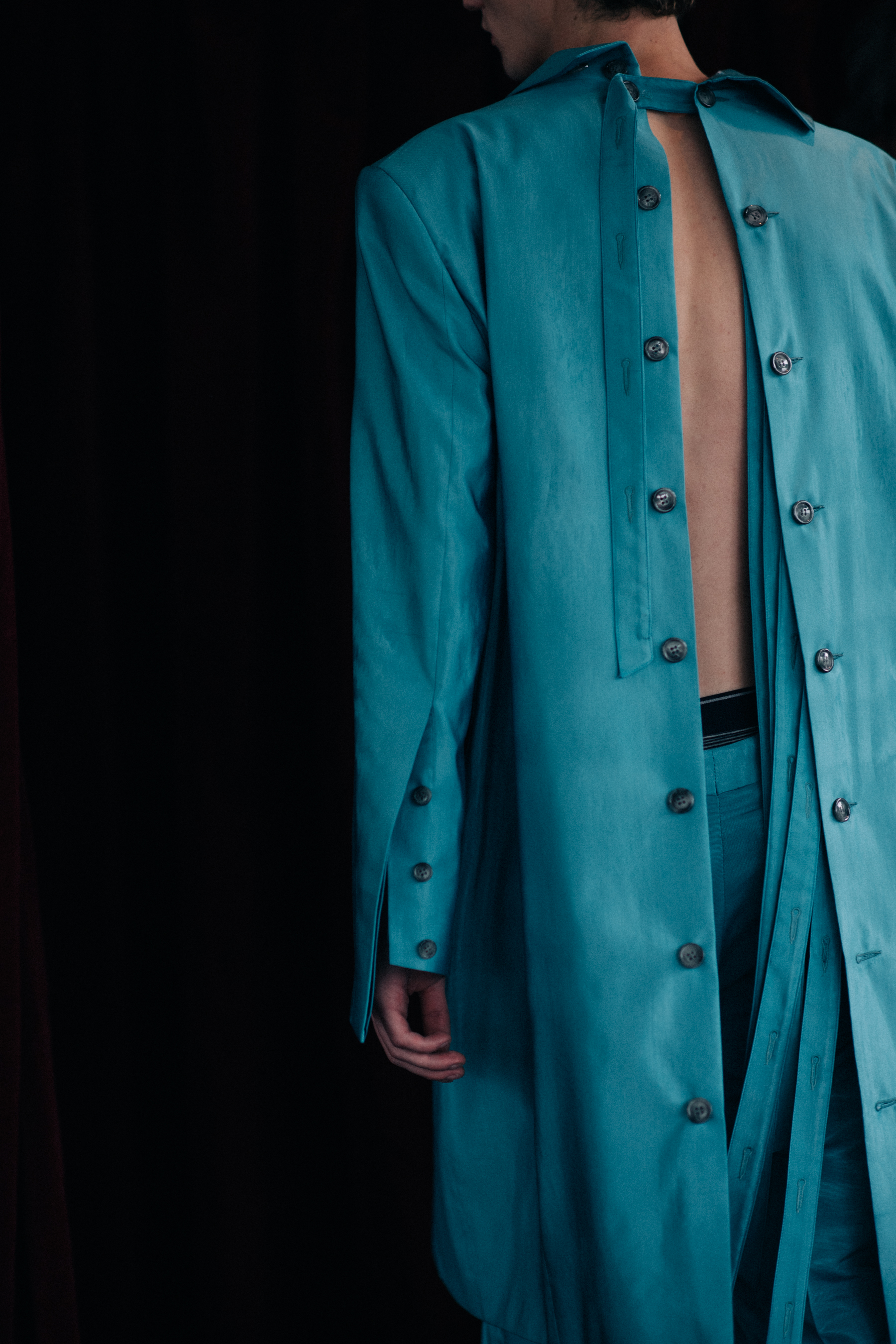 A lond turquoise coat