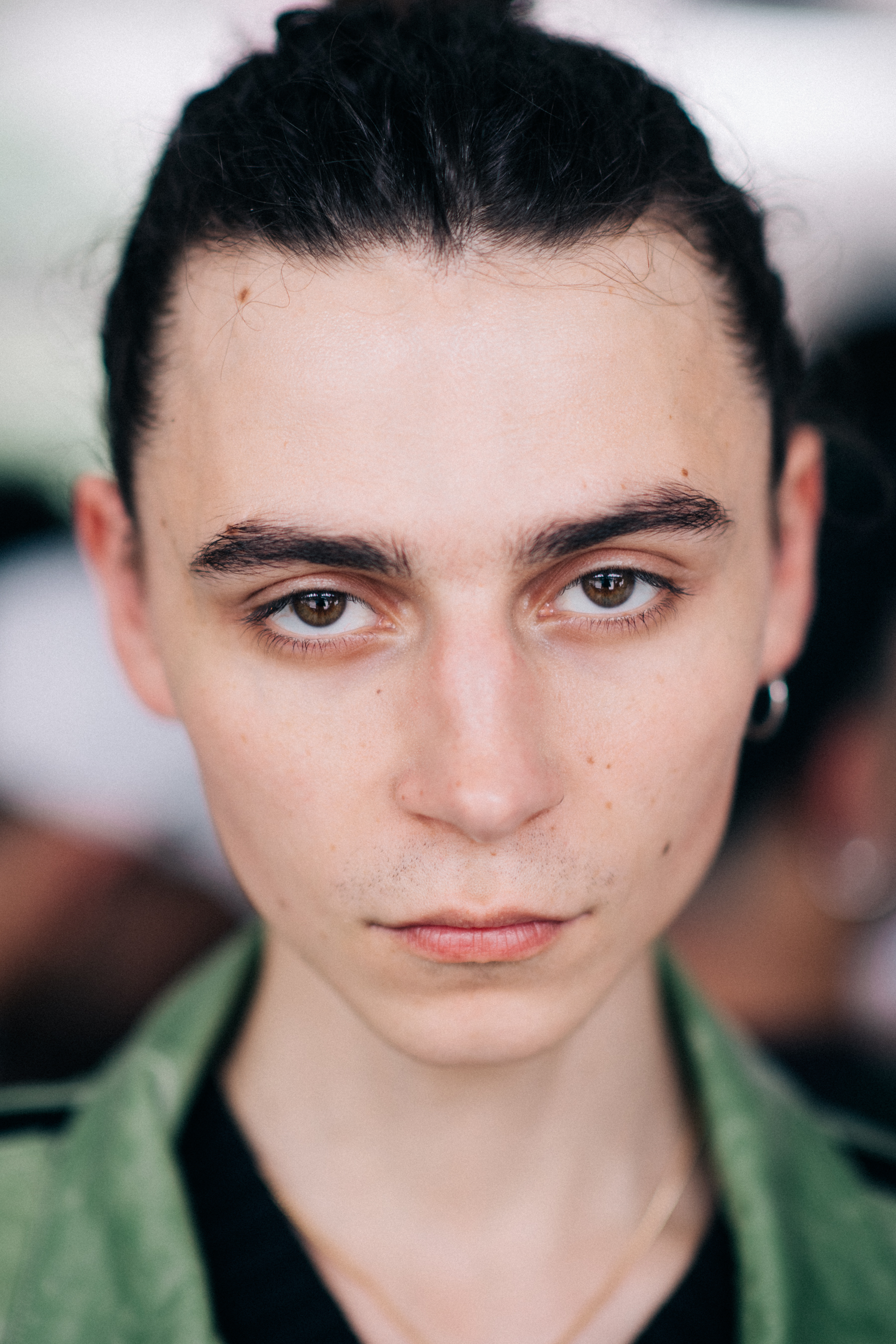 A male model in a green jacket