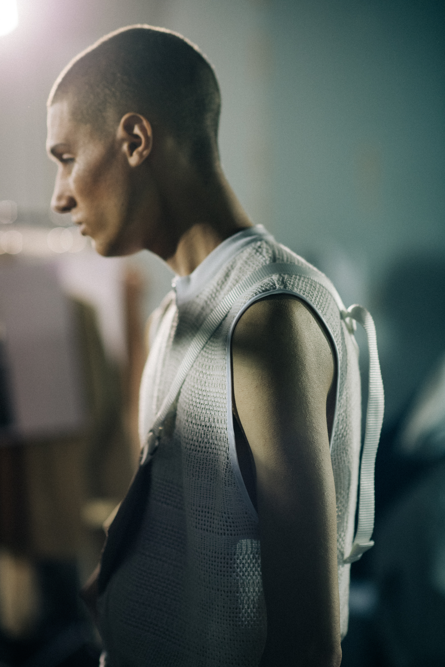 Male model wearing a sleeveless jacket
