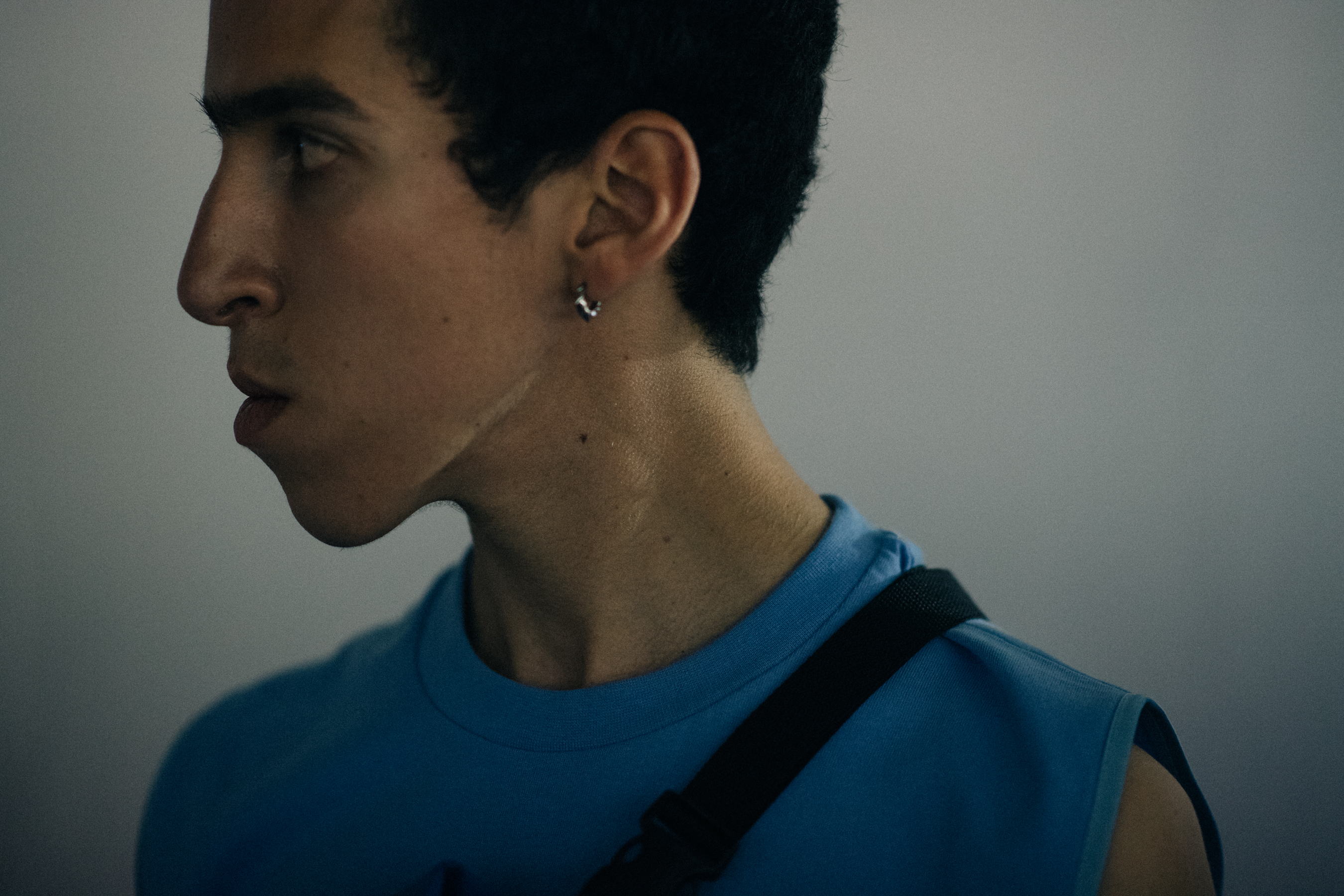 Model in a blue sleeveless T-Shirt