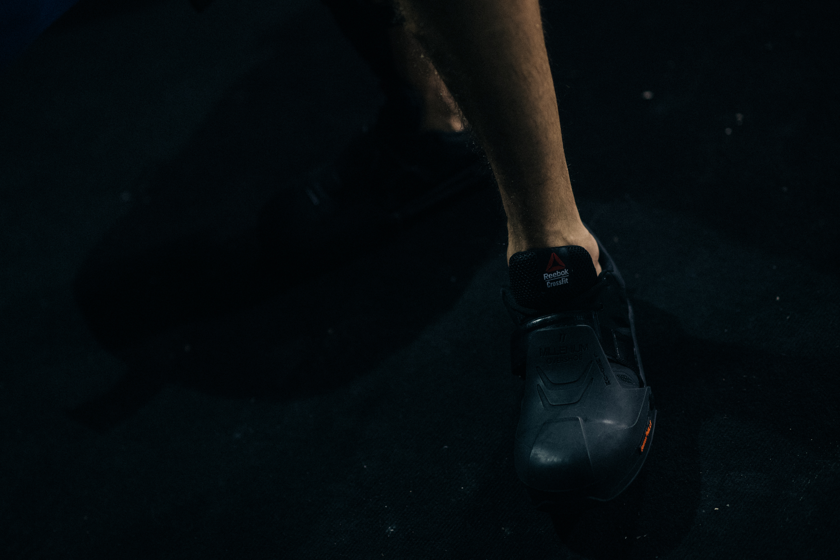 Feet of a model in black sneakers